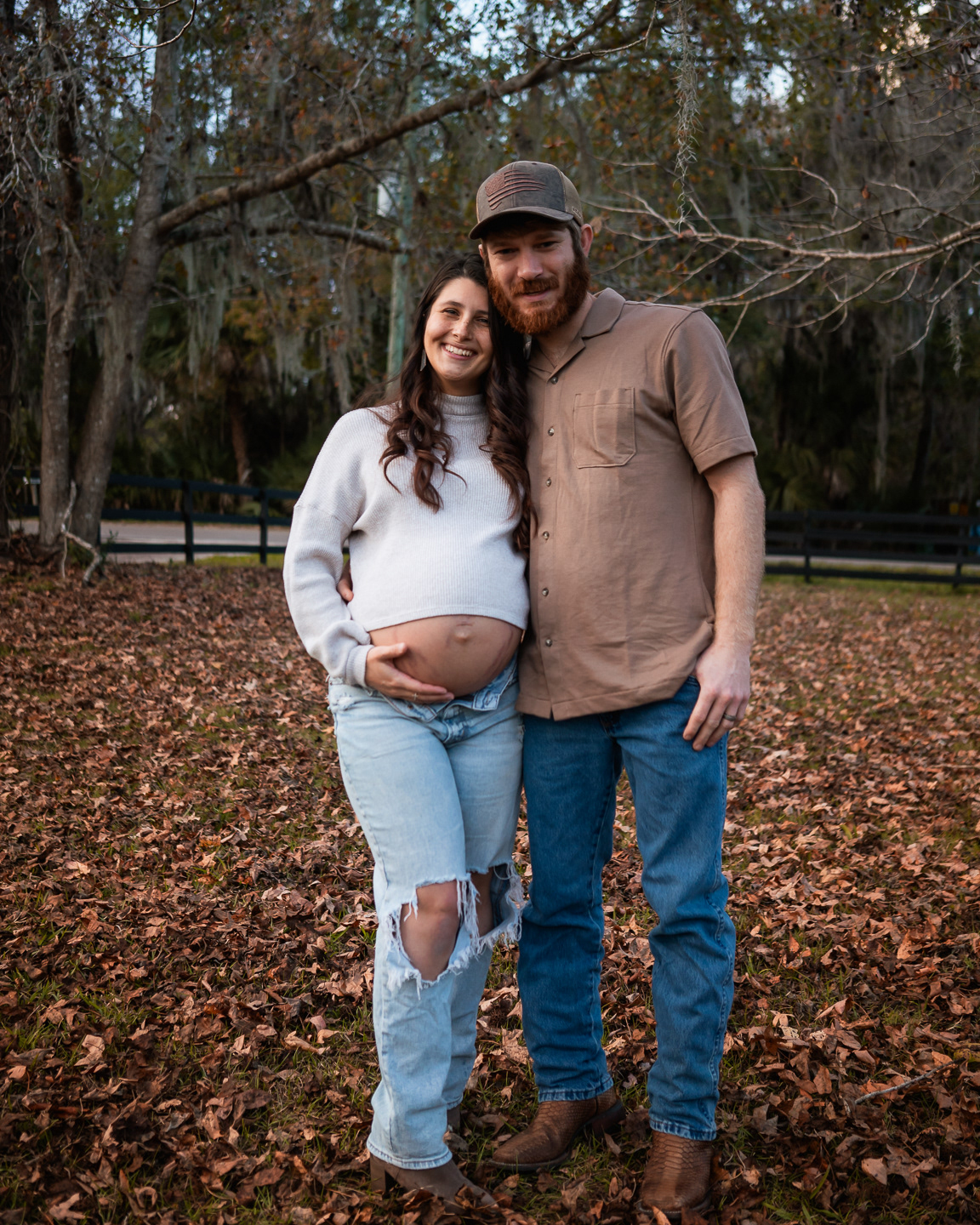 Couple maternity portrait in a wooded outdoor location in Florida
