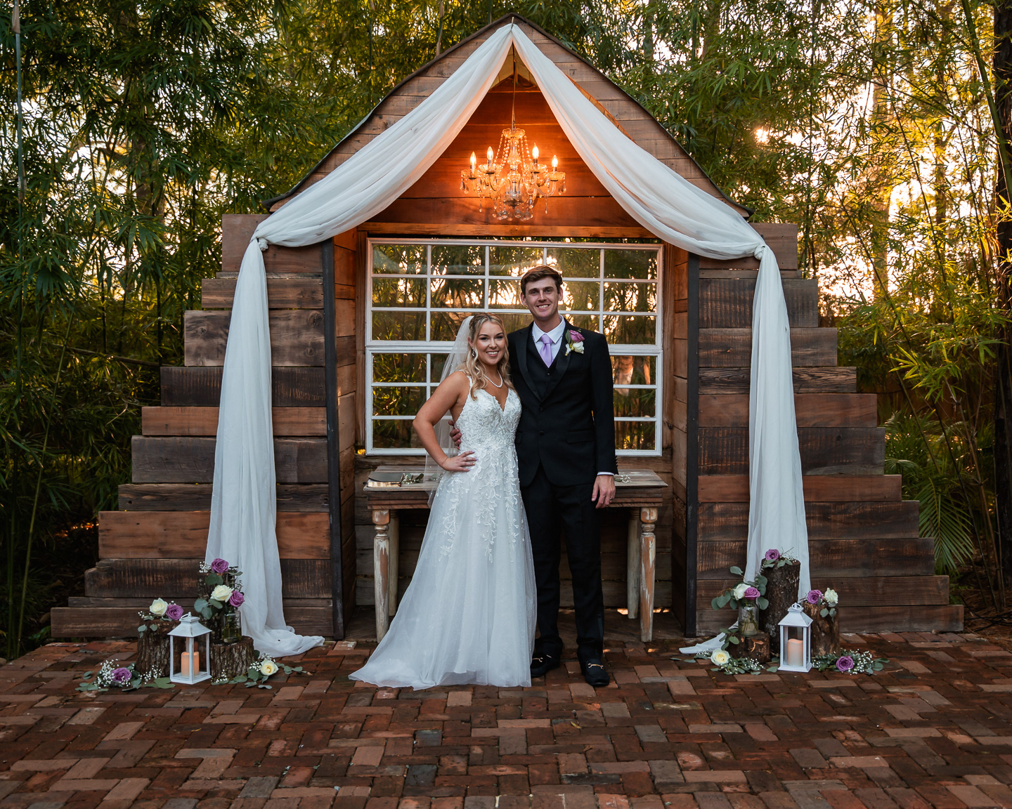 Bride and groom portrait in front of rustic chapel backdrop at Bridle Oaks Barn in DeLand Florida