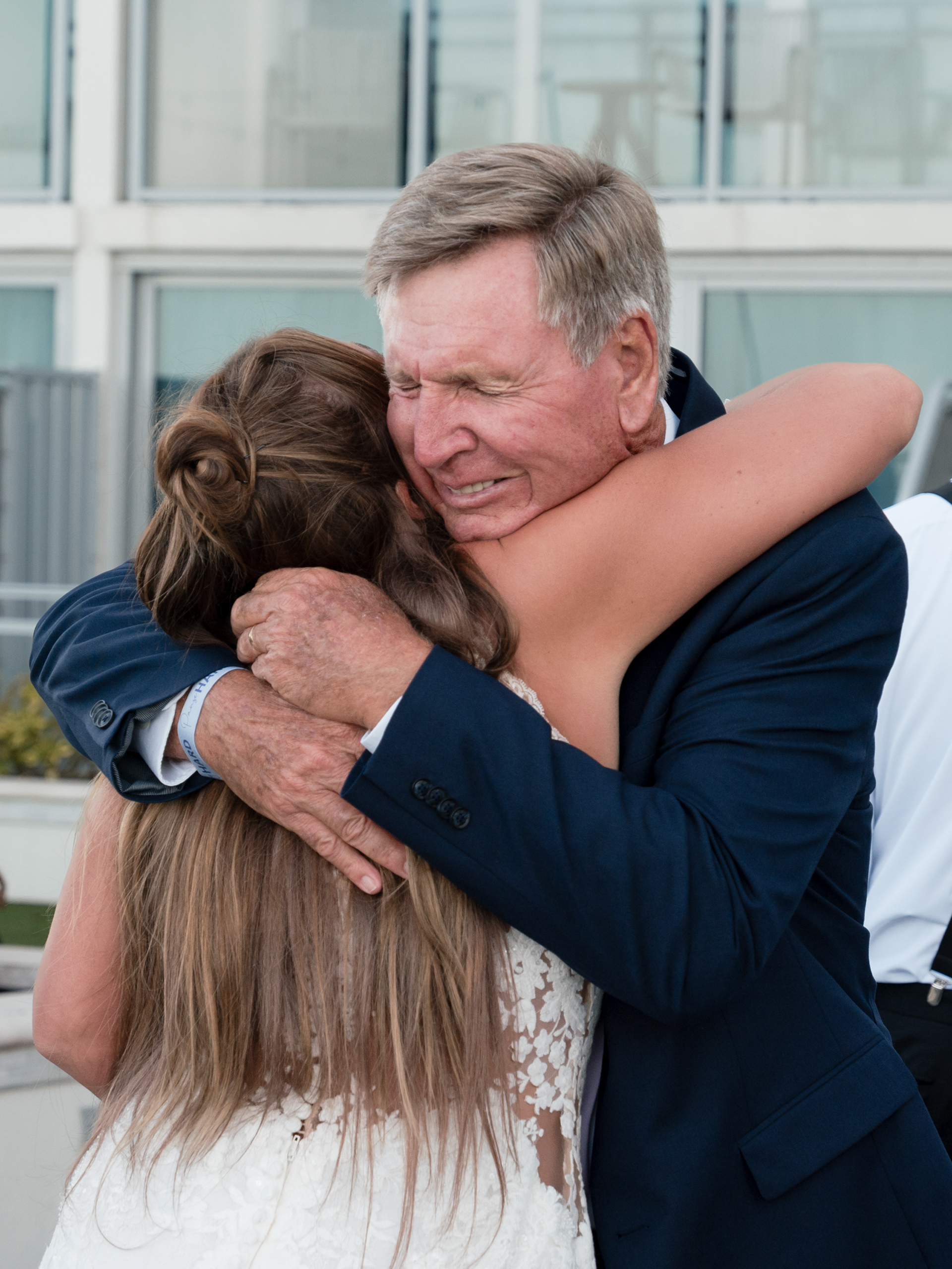 Emotional family hug during a Hard Rock Hotel Daytona Beach wedding.