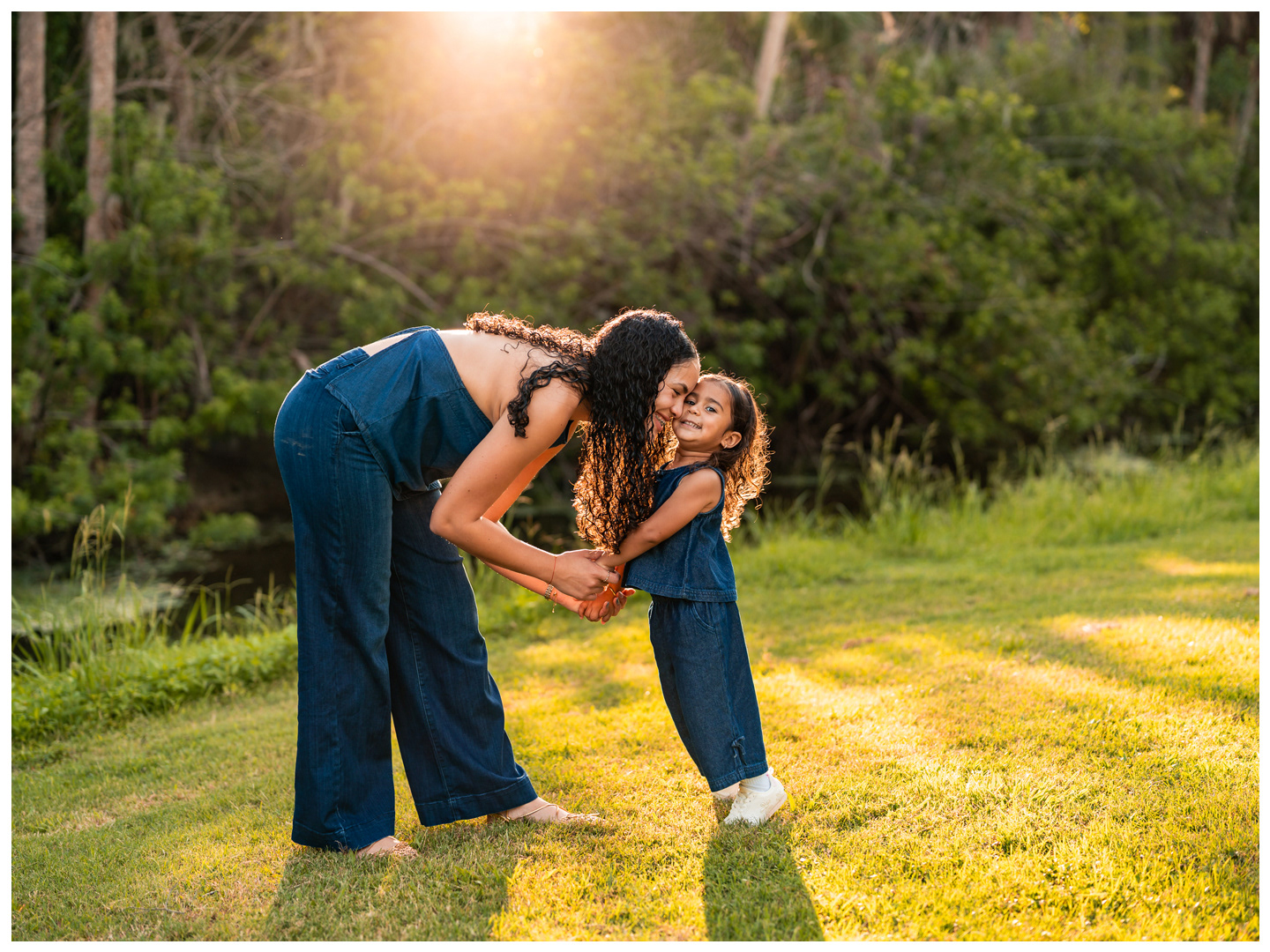 Mother holding daughter’s hands during family photos at Buschman Park in Port Orange