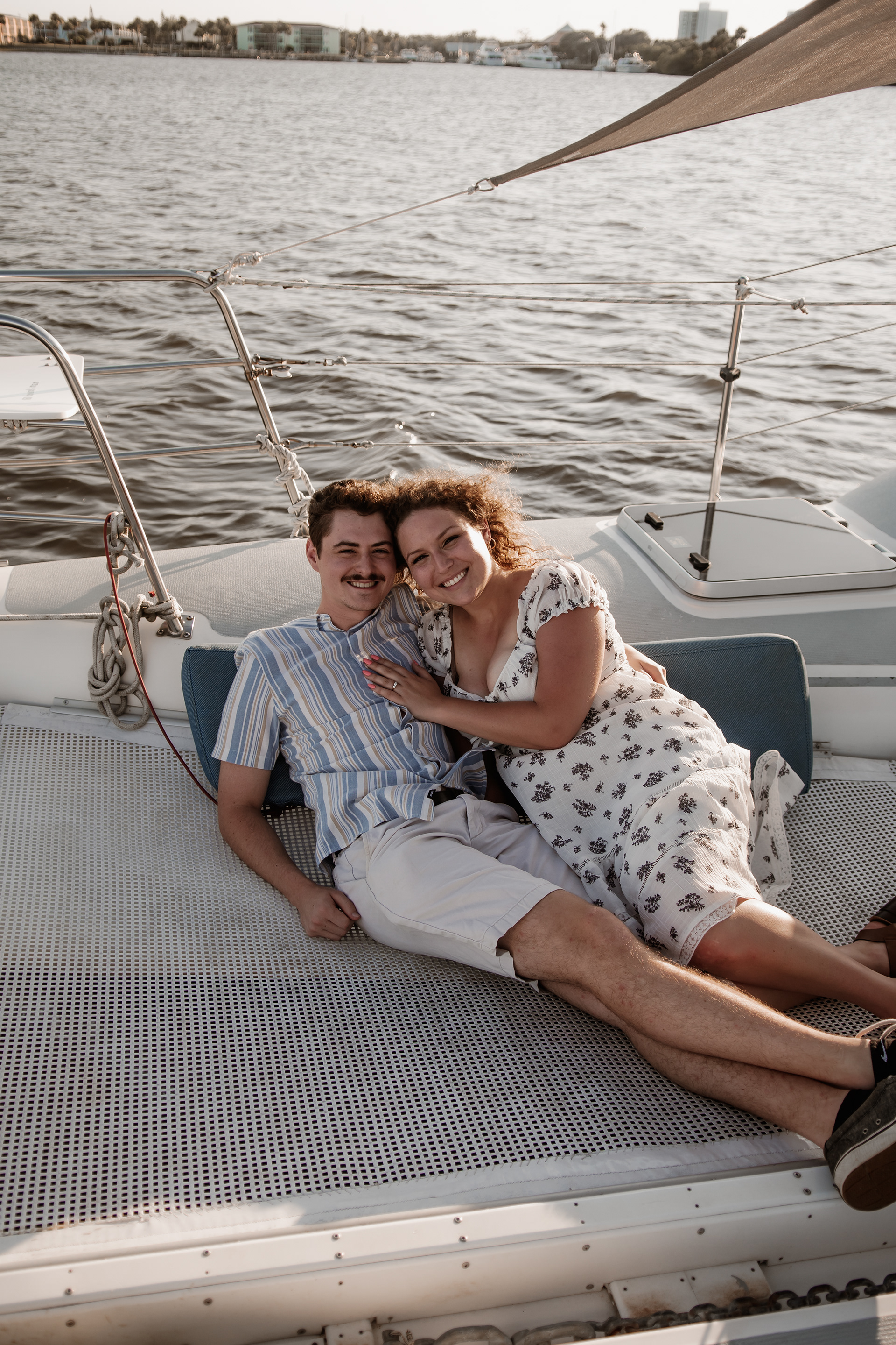Relaxed couple portrait on sailboat during Daytona Beach engagement photos