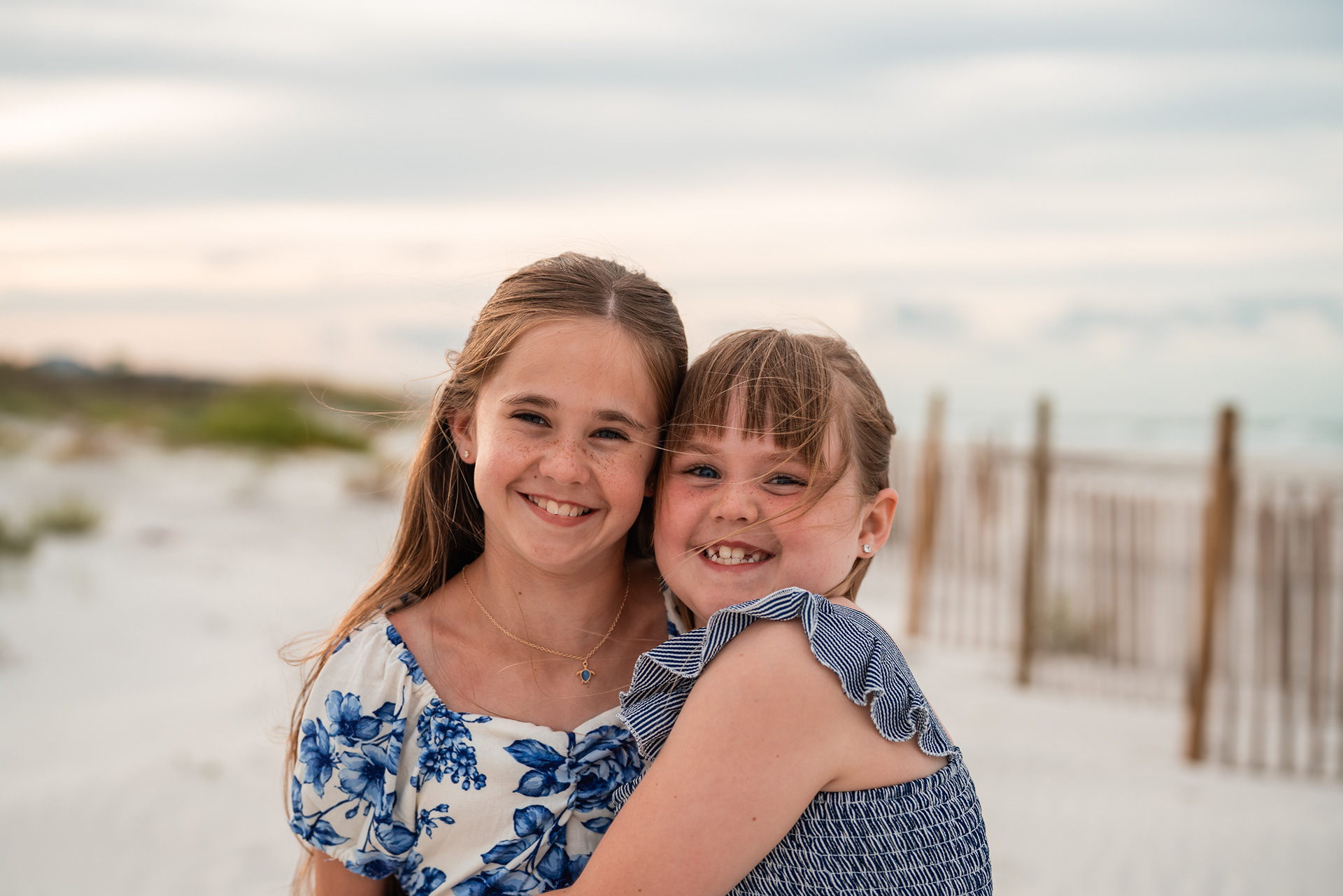 Sisters smiling together during a Ponce Inlet Beach family photography session.