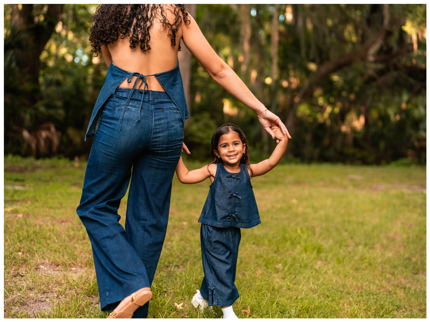 Mother and daughter walking hand in hand at Buschman Park in Port Orange