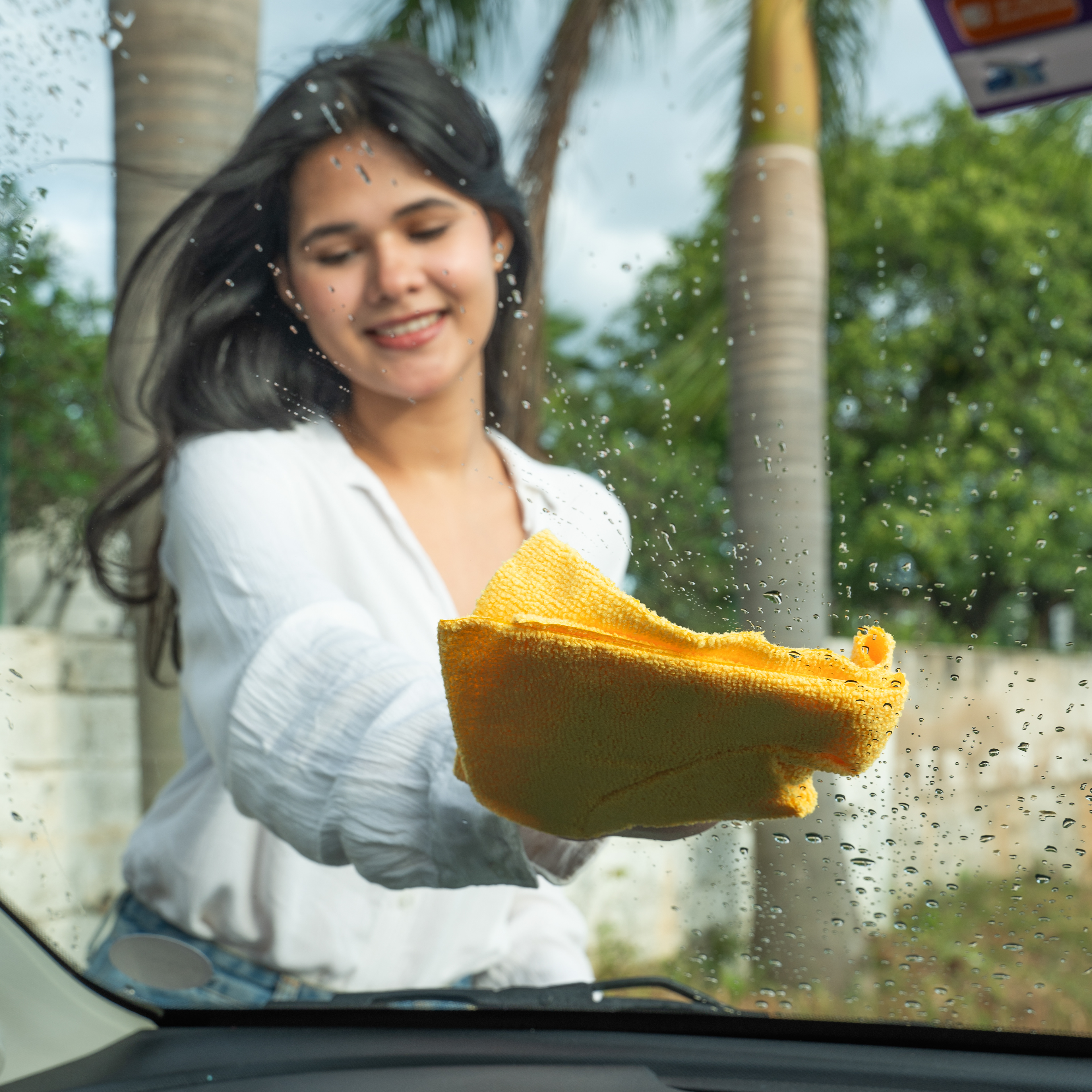 "Multipurpose towel rolls product shoot with a versatile model showcasing their usage on different surfaces for cleaning and convenience."