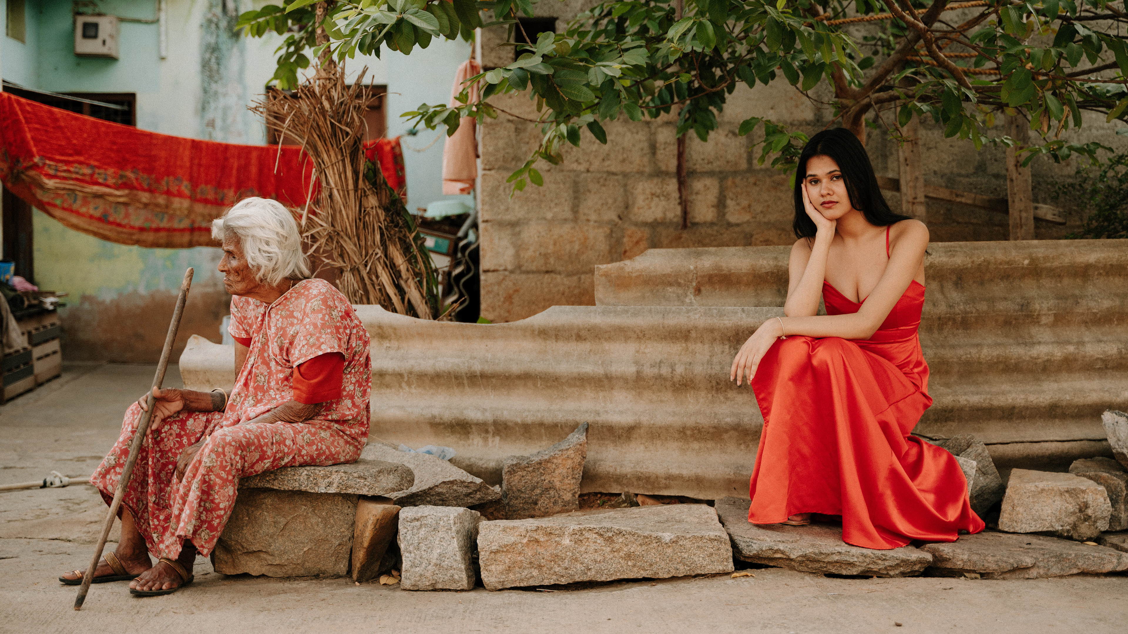 "Fashion photography in a rural setting: A girl in a vibrant red dress symbolizes the harmonious blend of modern and rural cultures, embodying two distinct aspects of life."