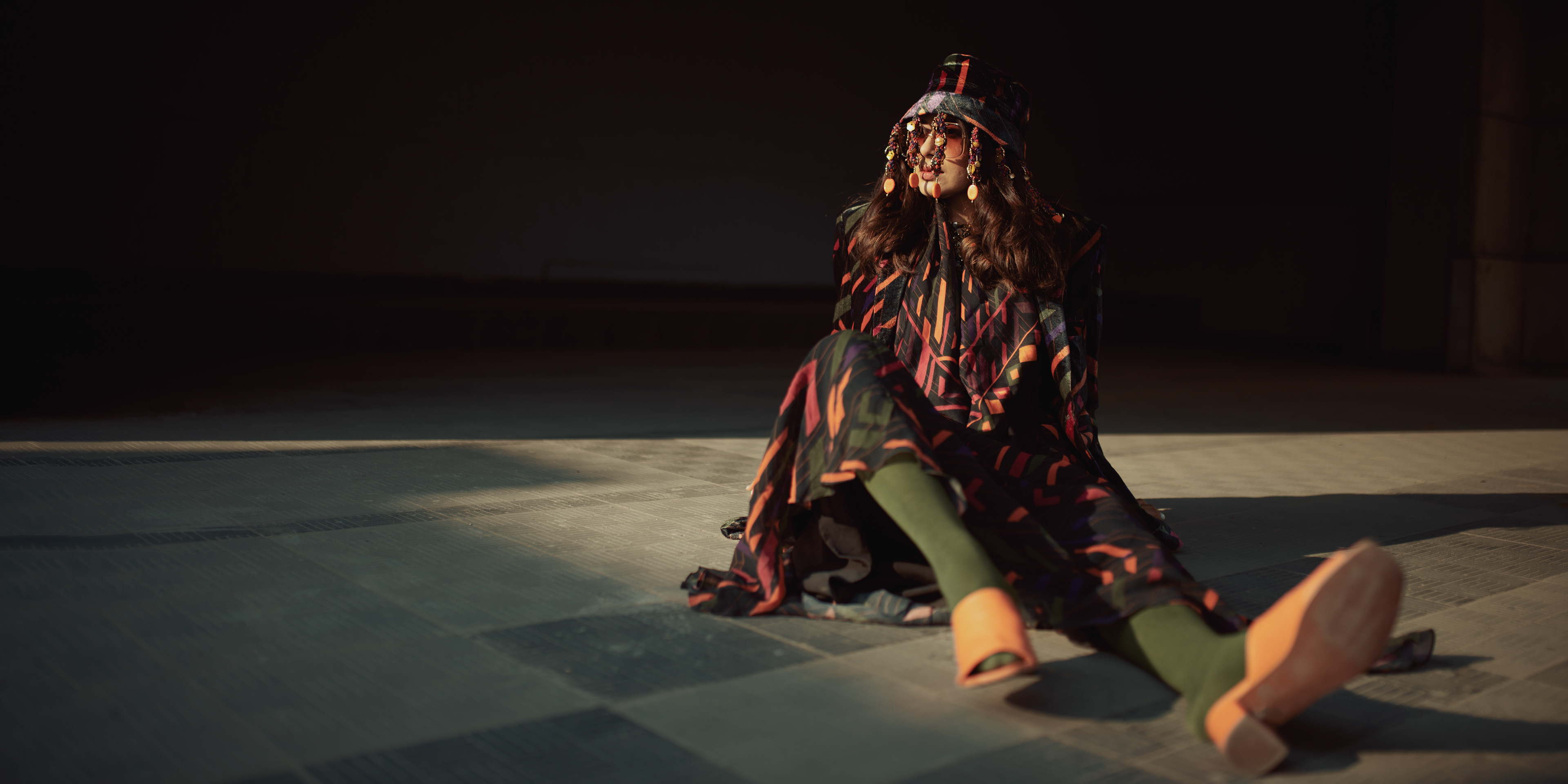 "Influencer shoot with a 'Caged Kaleidoscope' theme featuring a model wearing an elegant Nirmooha dress, showcasing a fusion of fashion and artistry."