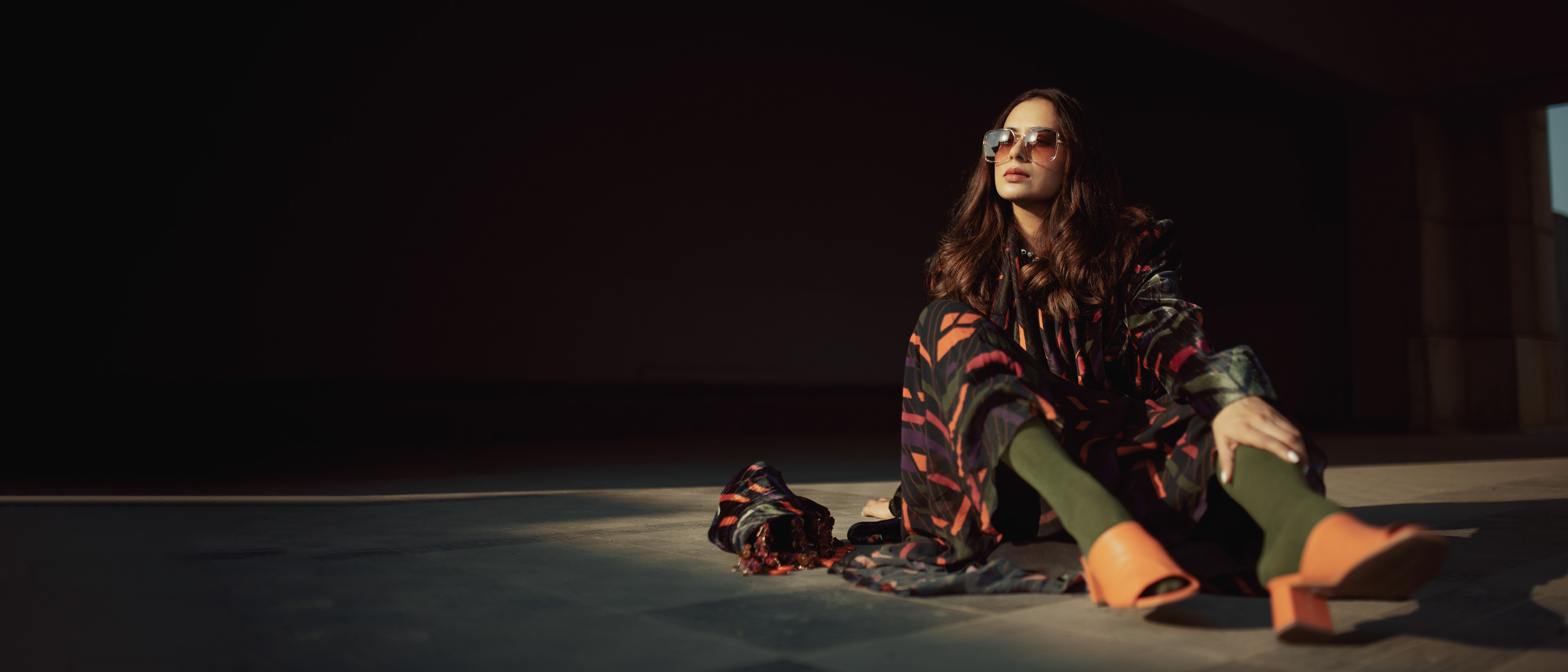 "Influencer shoot with a 'Caged Kaleidoscope' theme featuring a model wearing an elegant Nirmooha dress, showcasing a fusion of fashion and artistry."