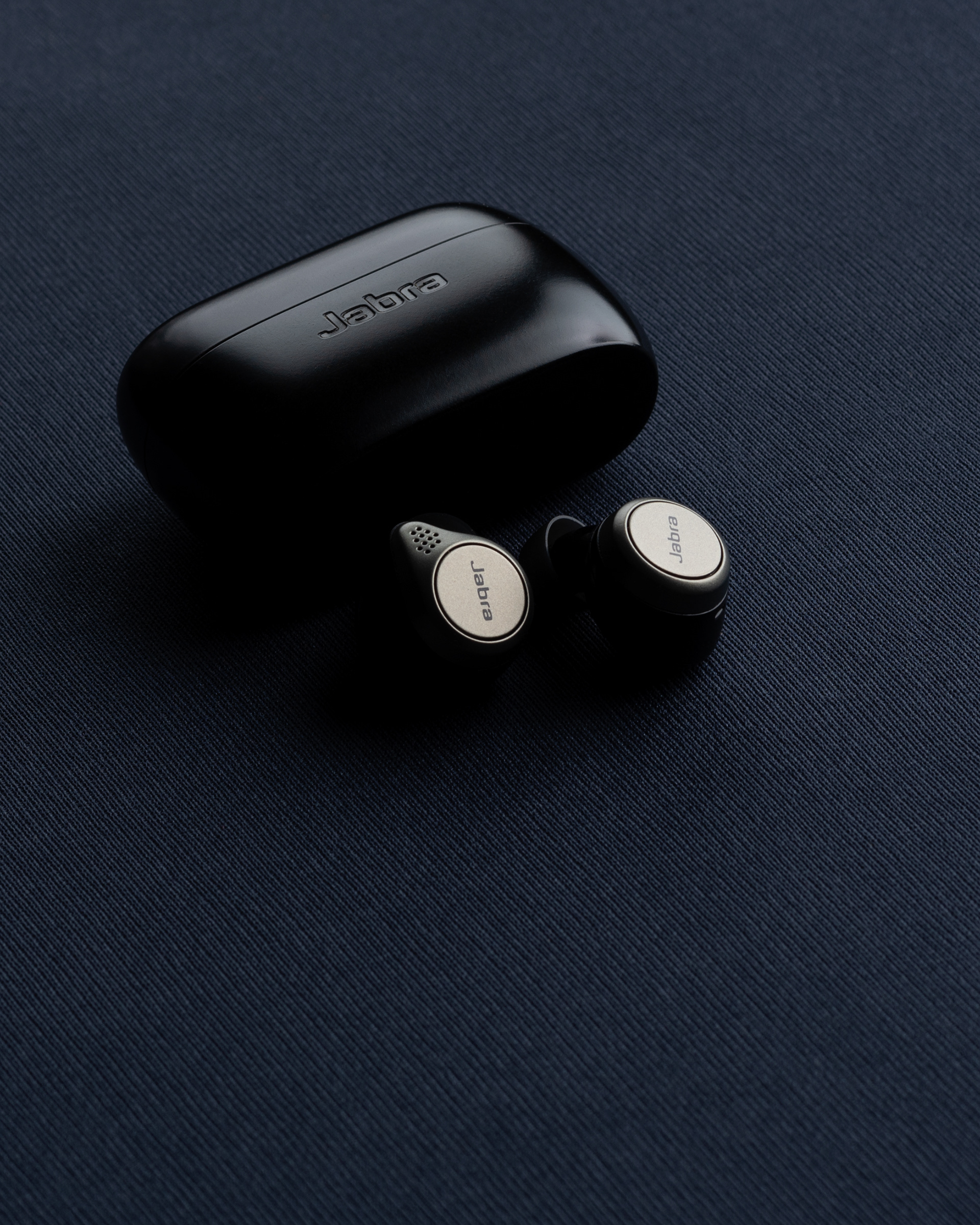  "Jabra EarPods on a sleek blue backdrop, showcasing a minimalistic design for a modern audio experience."