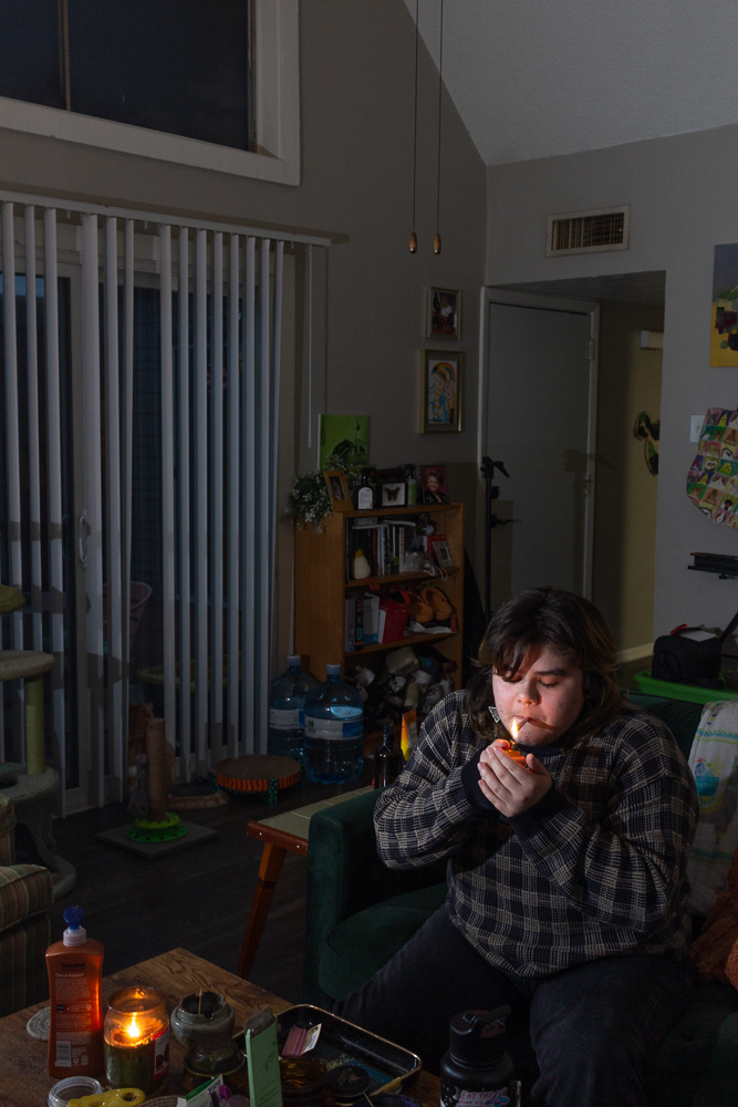 Sam lighting their joint, 2022