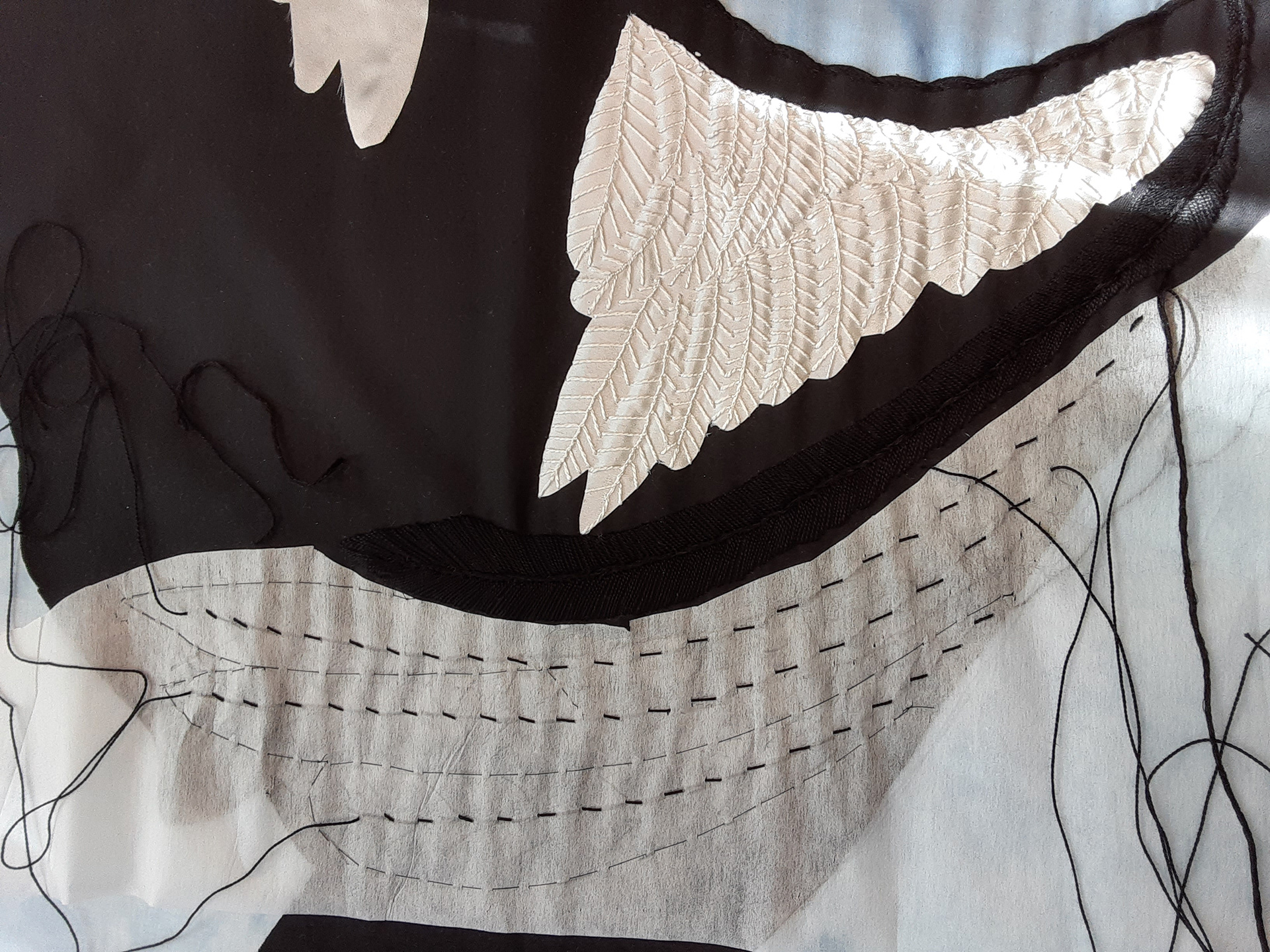 Dorsal side of primary feathers, black satin stitch & couching embroidery