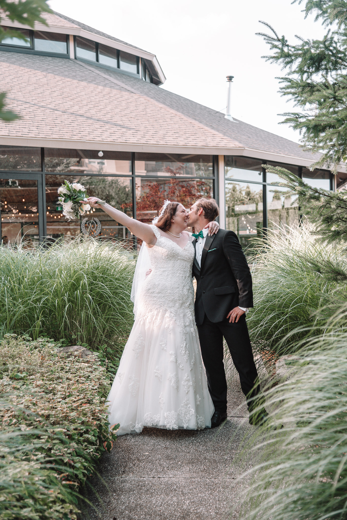 K & J kissing in front of their venue.