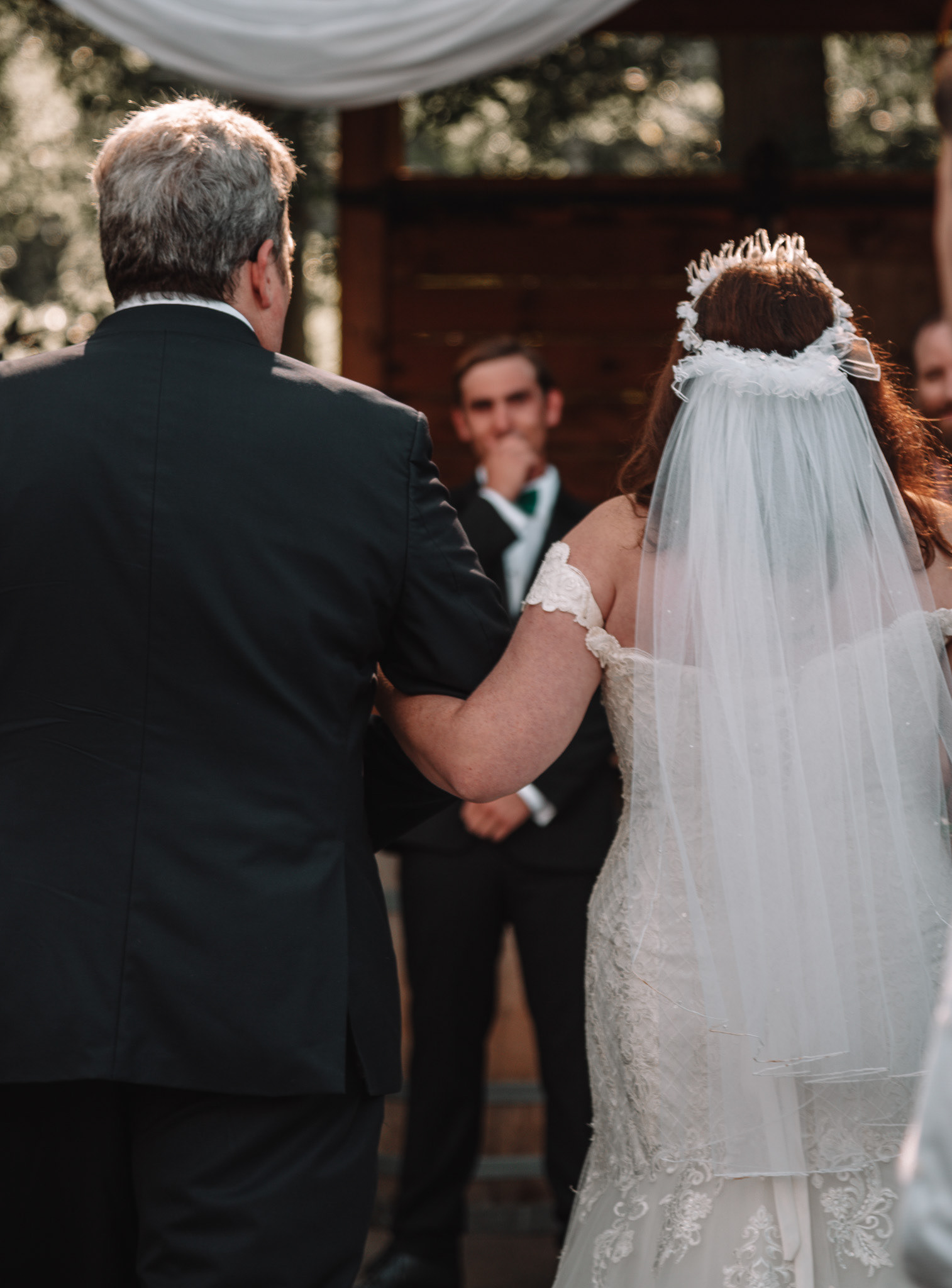 J crying as K walks down the aisle with her dad.