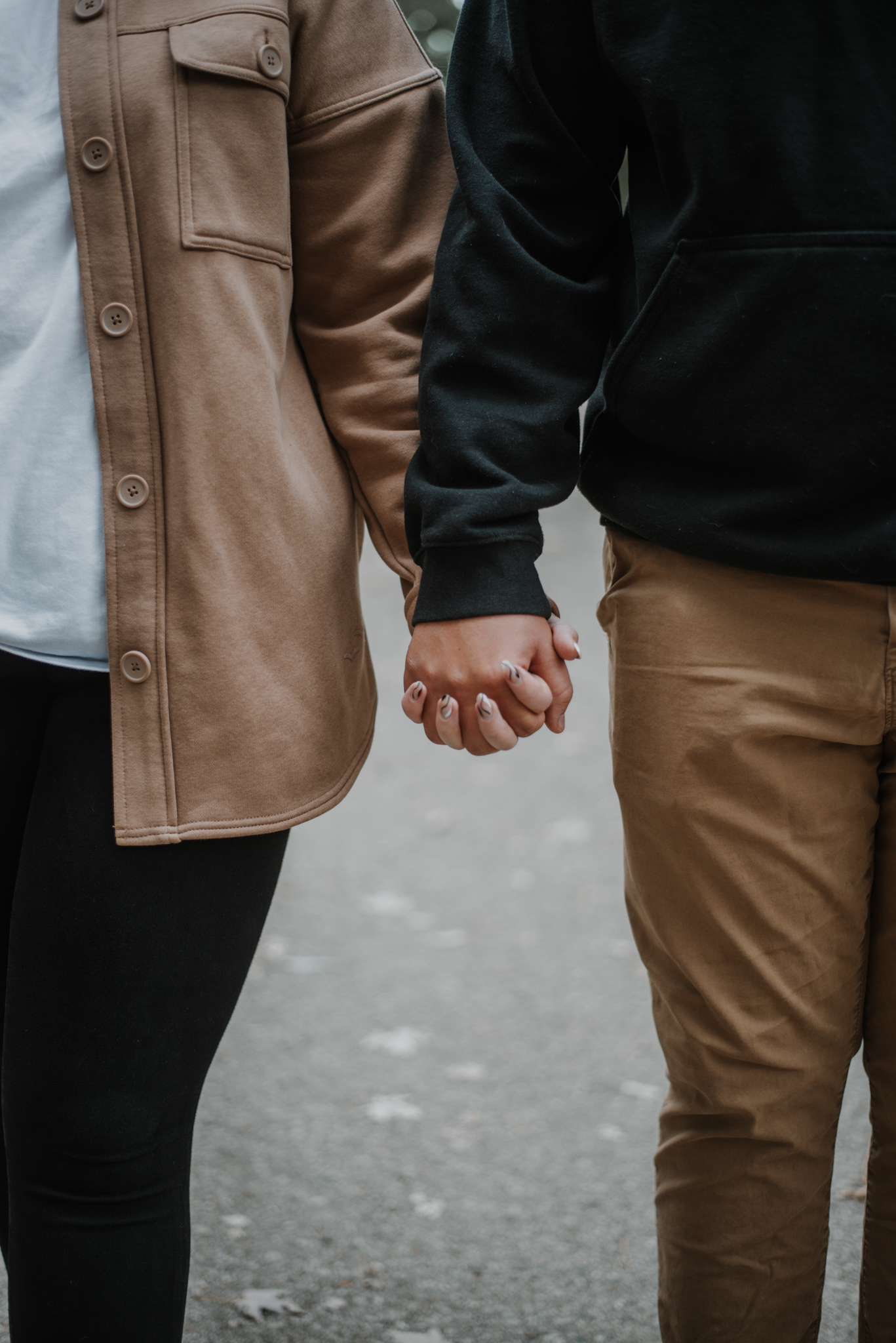 A & J closeup of holding hands.