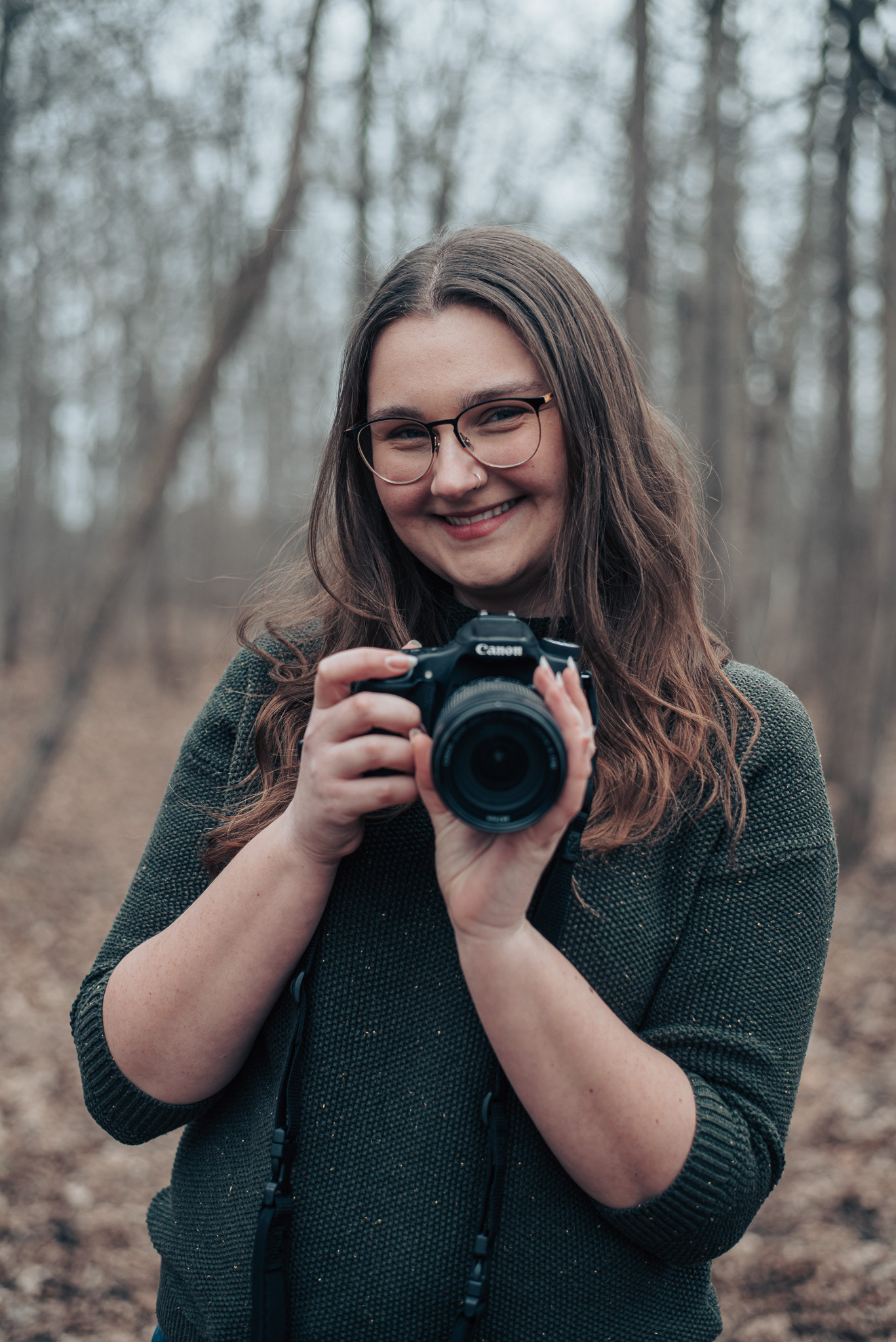 Headshot of Allison with her camera.