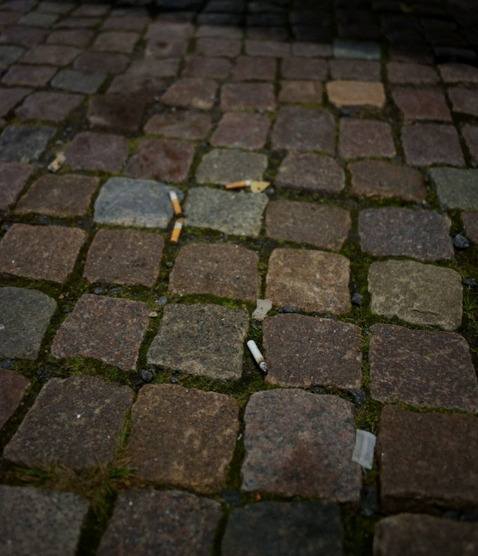 Cigarette butts & tobacco pouches around bench 3 point towards a behaviour which is popular, if not endorsed by planners.