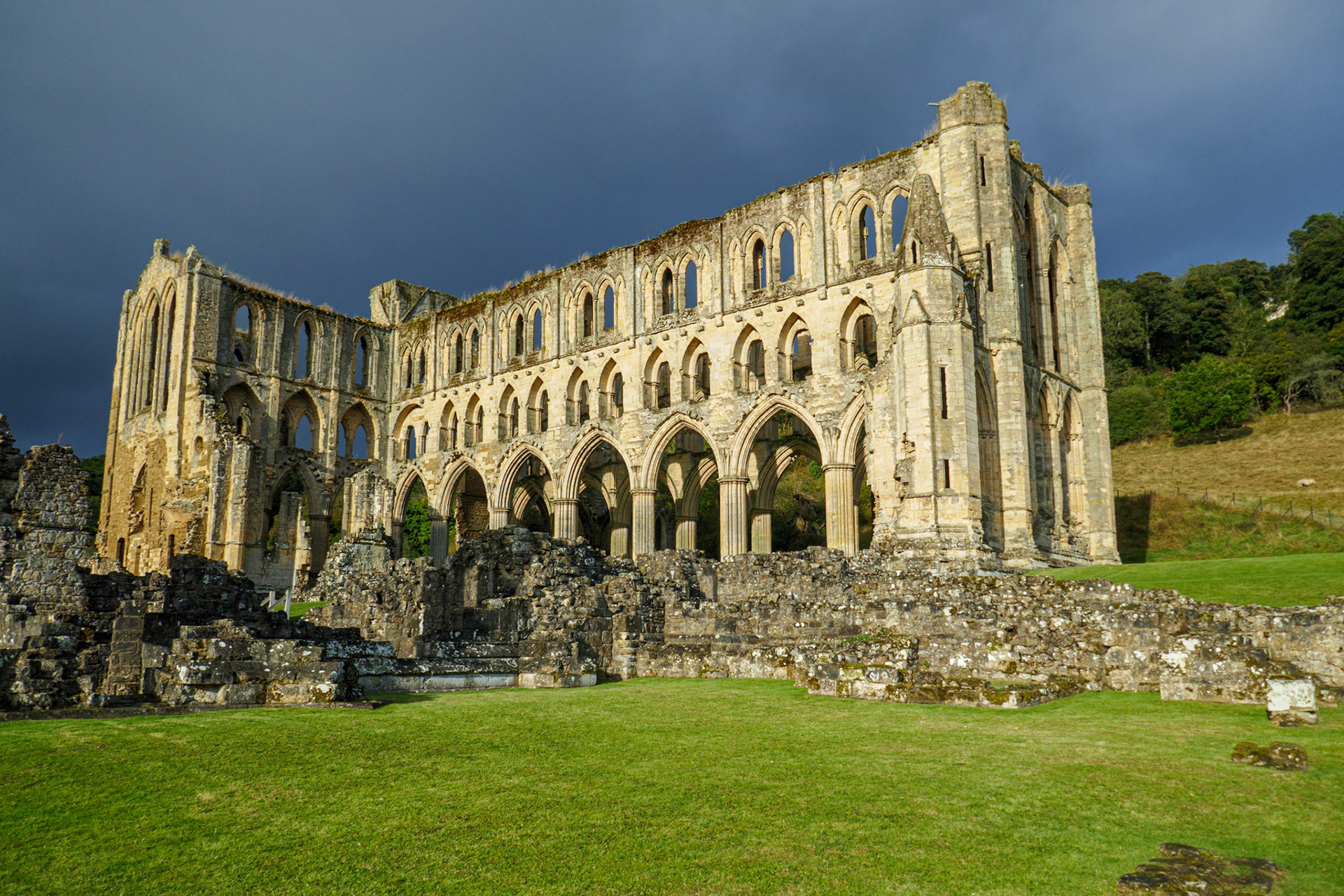 Rievaulx Abbey against a dark sky