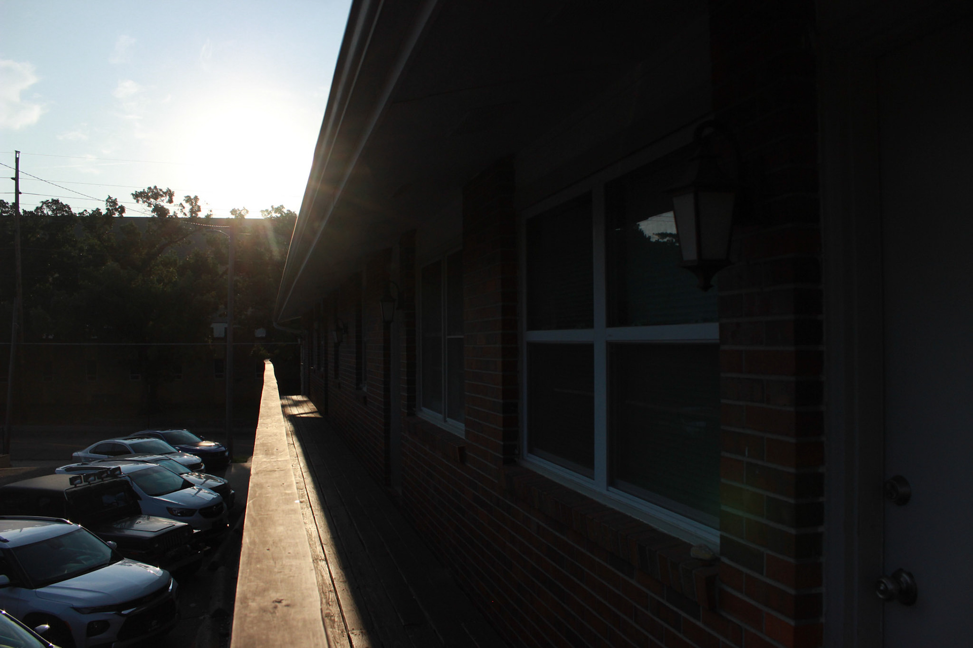 Taken on the balcony of the Glenwood apartments, the banister leads the eye towards the sun, or maybe the sun leads to the banister? The bright morning sun lights the Manhattan area for students walking and driving to school.