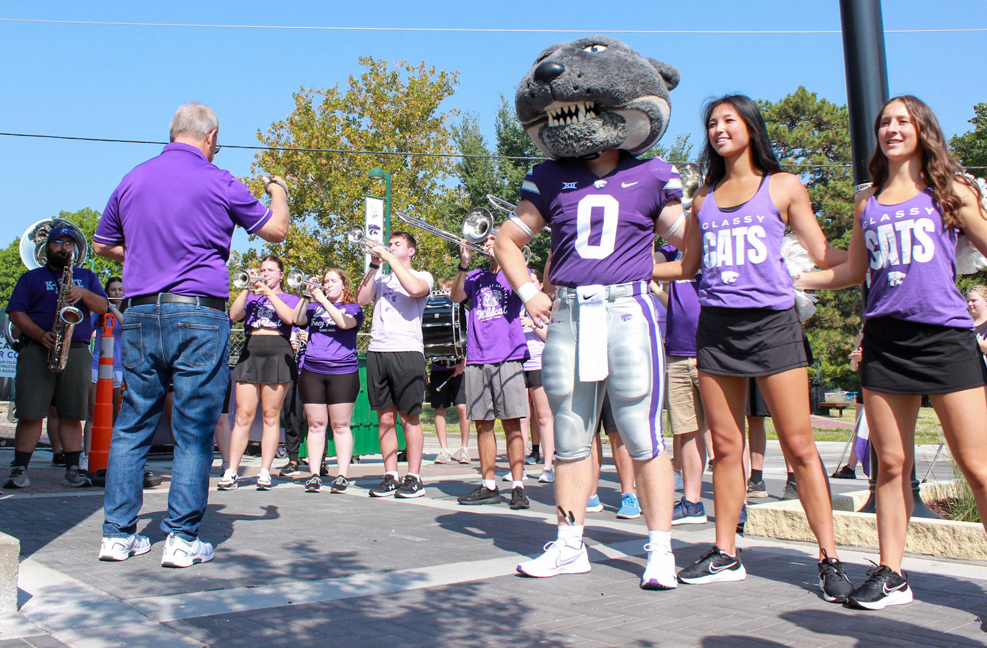 A partial Pride of Wildcat Nation played for the ceremony. Band director Frank Tracz conducts as Willie the Wildcats and the Classy Cats sway to Alma Mater.
