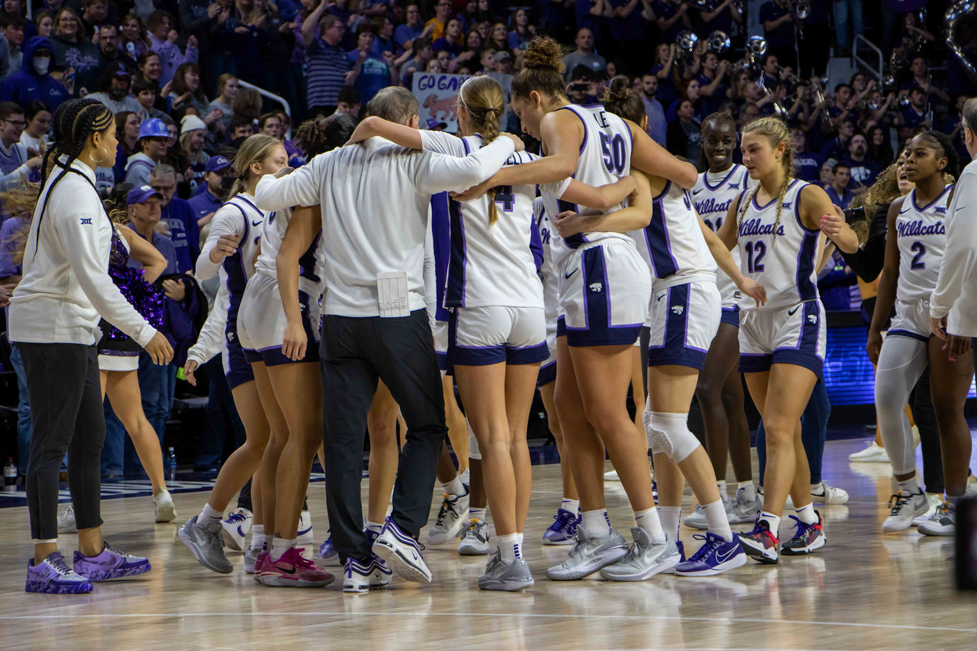 Head coach Jeff Mittie corrals his players in a circle to say a few words following K-State's win. No. 12 K-State beat No. 10 Texas 61-58 Jan. 13, 2024.
