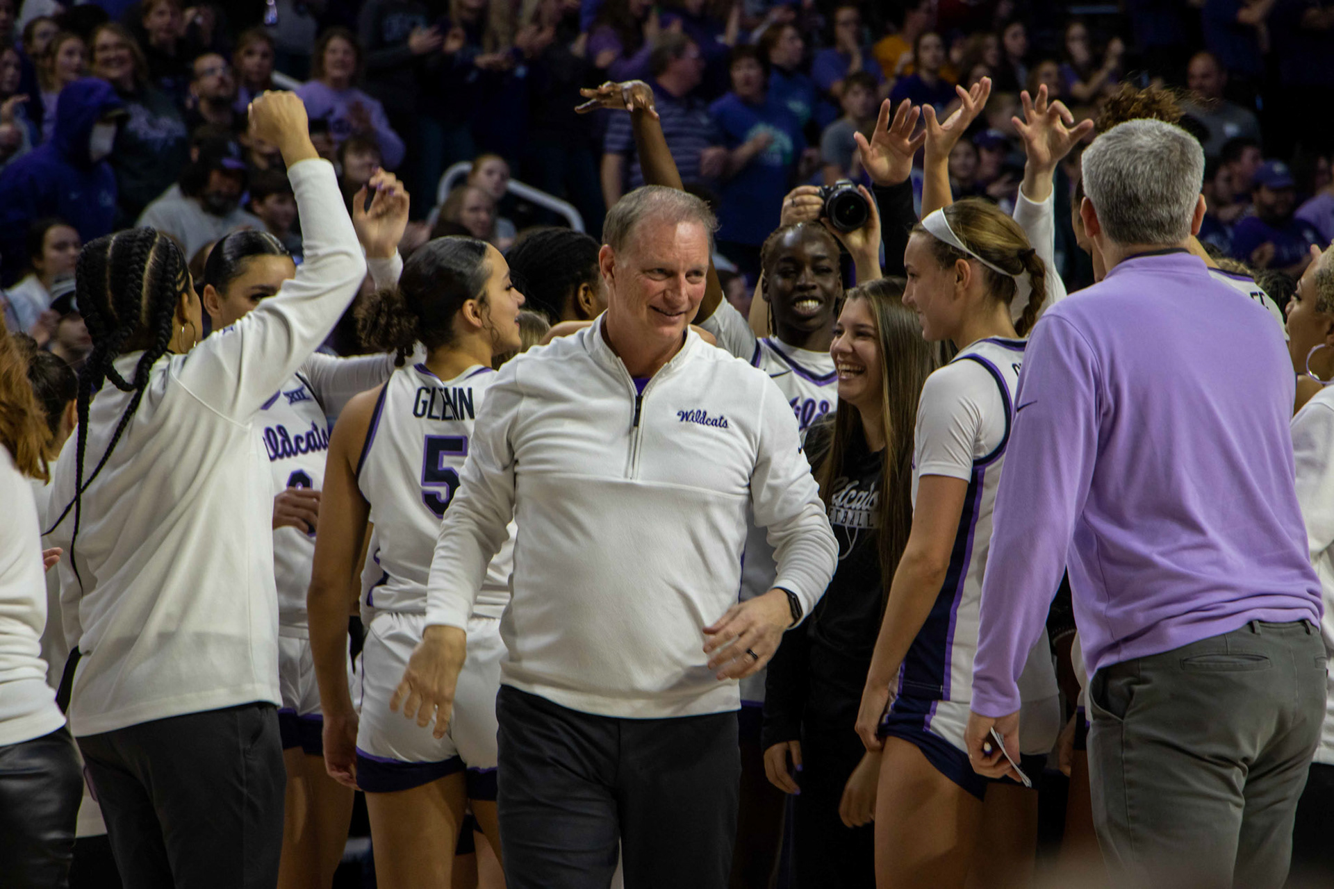 Head coach Jeff Mittie flashes a big grin after breaking it down with his players following K-State's win. No. 12 K-State beat No. 10 Texas 61-58 Jan. 13, 2024.