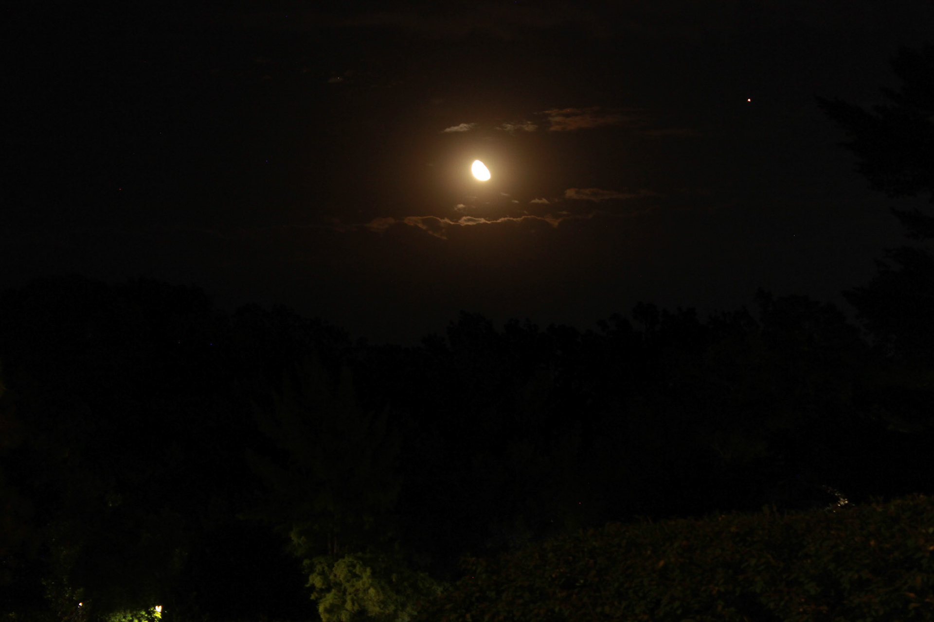 Saturn can be seen to the right of the moon