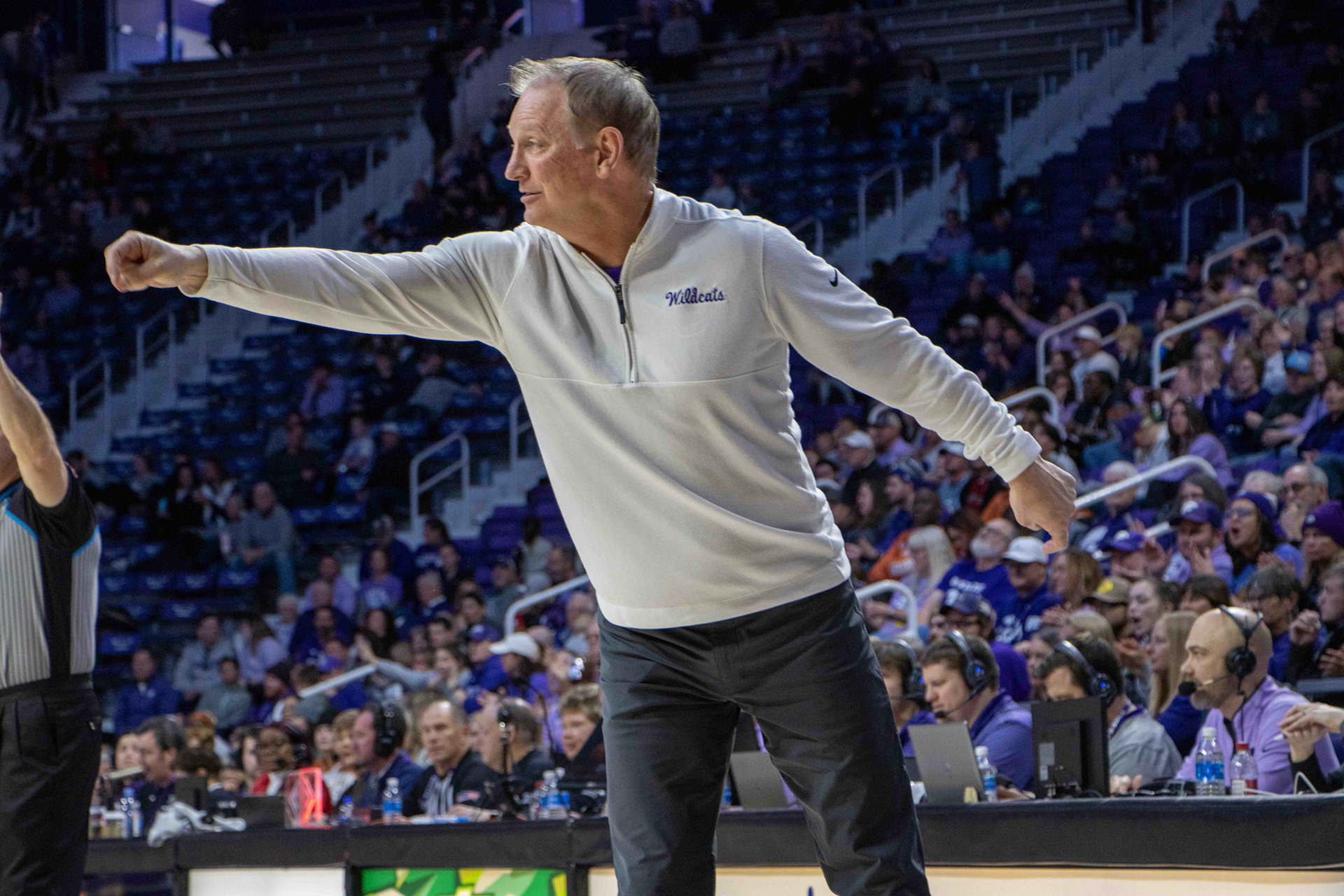 Head coach Jeff Mittie smiles as he directs the offense. His direction pays off as guard Serena Sundell sinks a layup to grow K-State's lead 48-45.