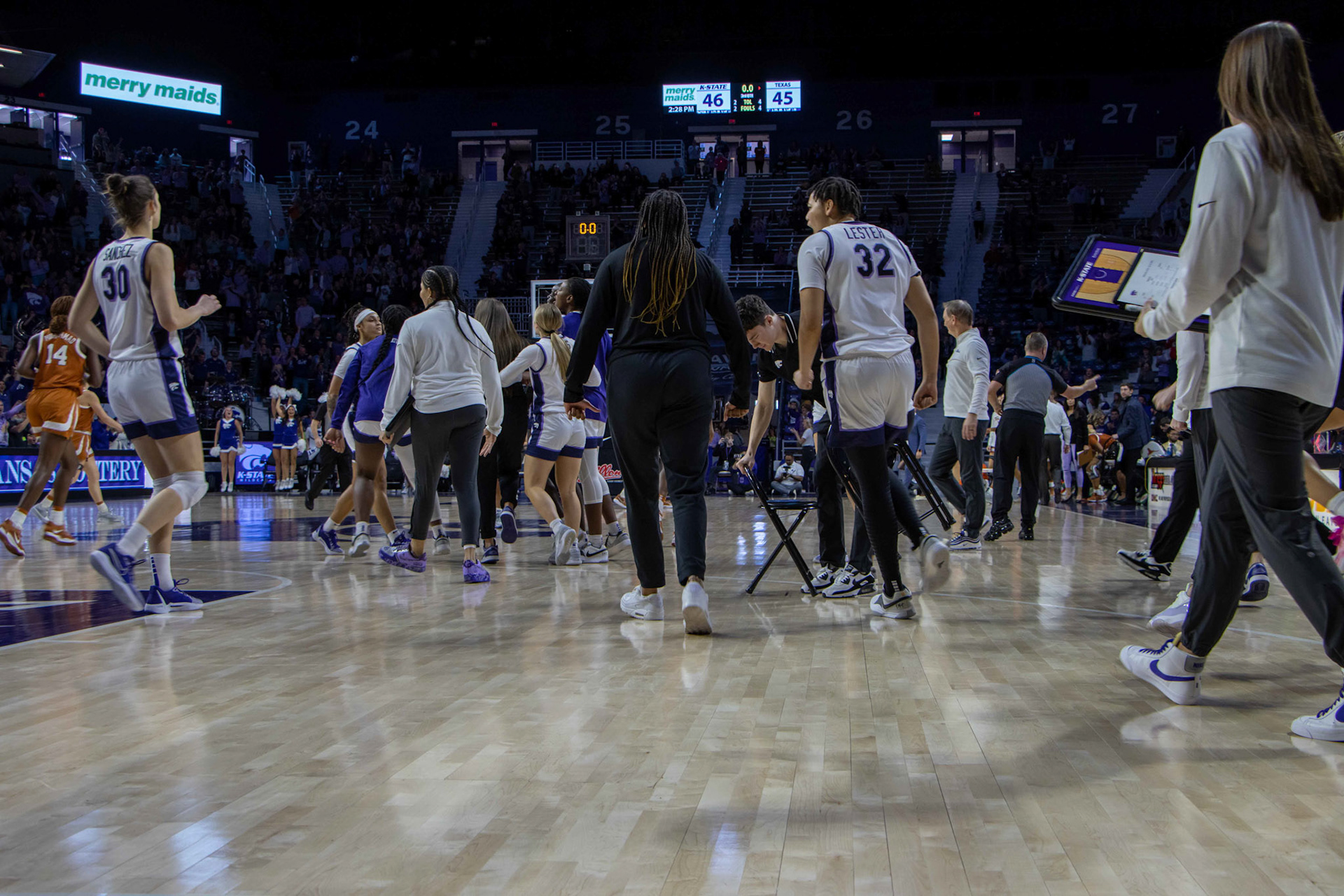 Guard Zyanna Walker walks to her teammates who stormed the court following Walker's 3-point third quarter buzzer beater. Walker's 3 gave K-State the lead back going into the fourth 46-45.