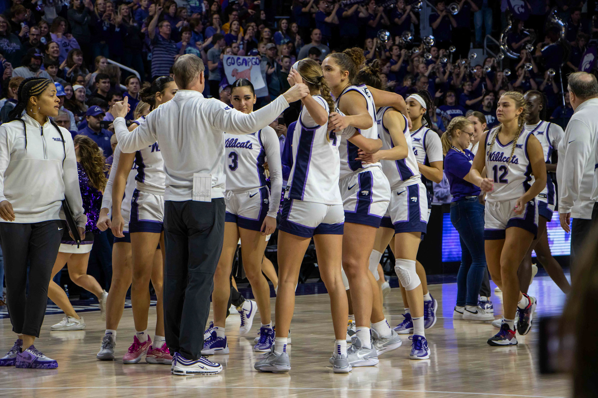 Head coach Jeff Mittie corrals his players in a circle to say a few words following K-State's win. No. 12 K-State beat No. 10 Texas 61-58 Jan. 13, 2024.