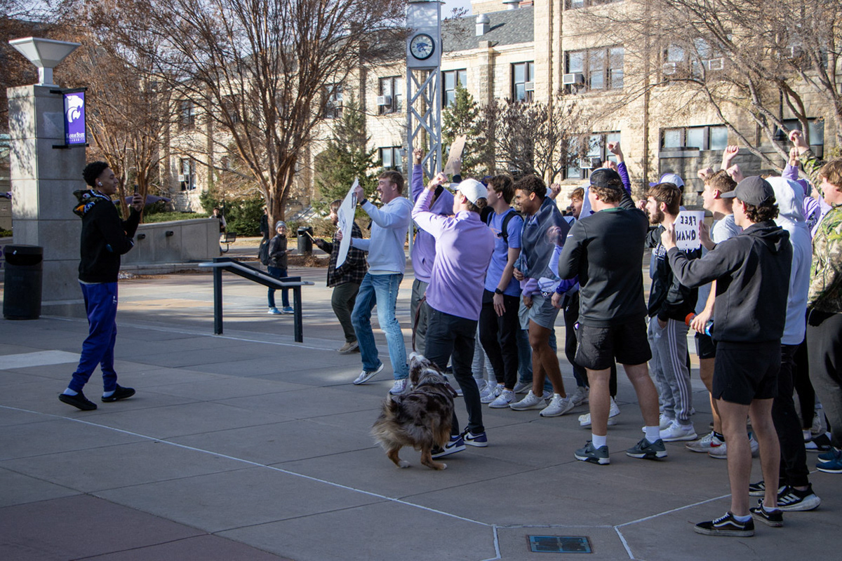 Guard Dorian Finister greets people protesting over Nae'Qwan Tomlin's suspension in Bosco Plaza. Finister did not join the protestors. (Featured in the Collegian)