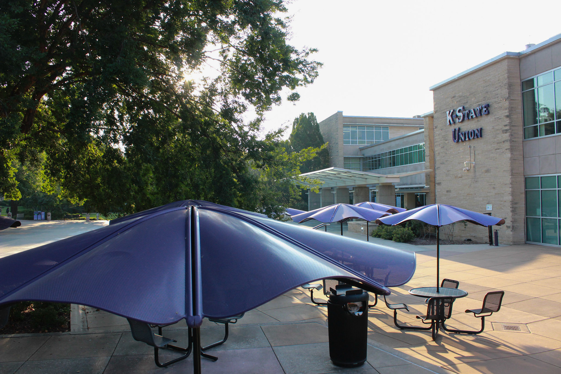 Purple umbrellas outside the Kansas State Student Union provide cover from the elements for passersby to study, eat lunch or chat. The Union is the social hub in the middle of campus, providing meal options, shopping, entertainment and student resources.
