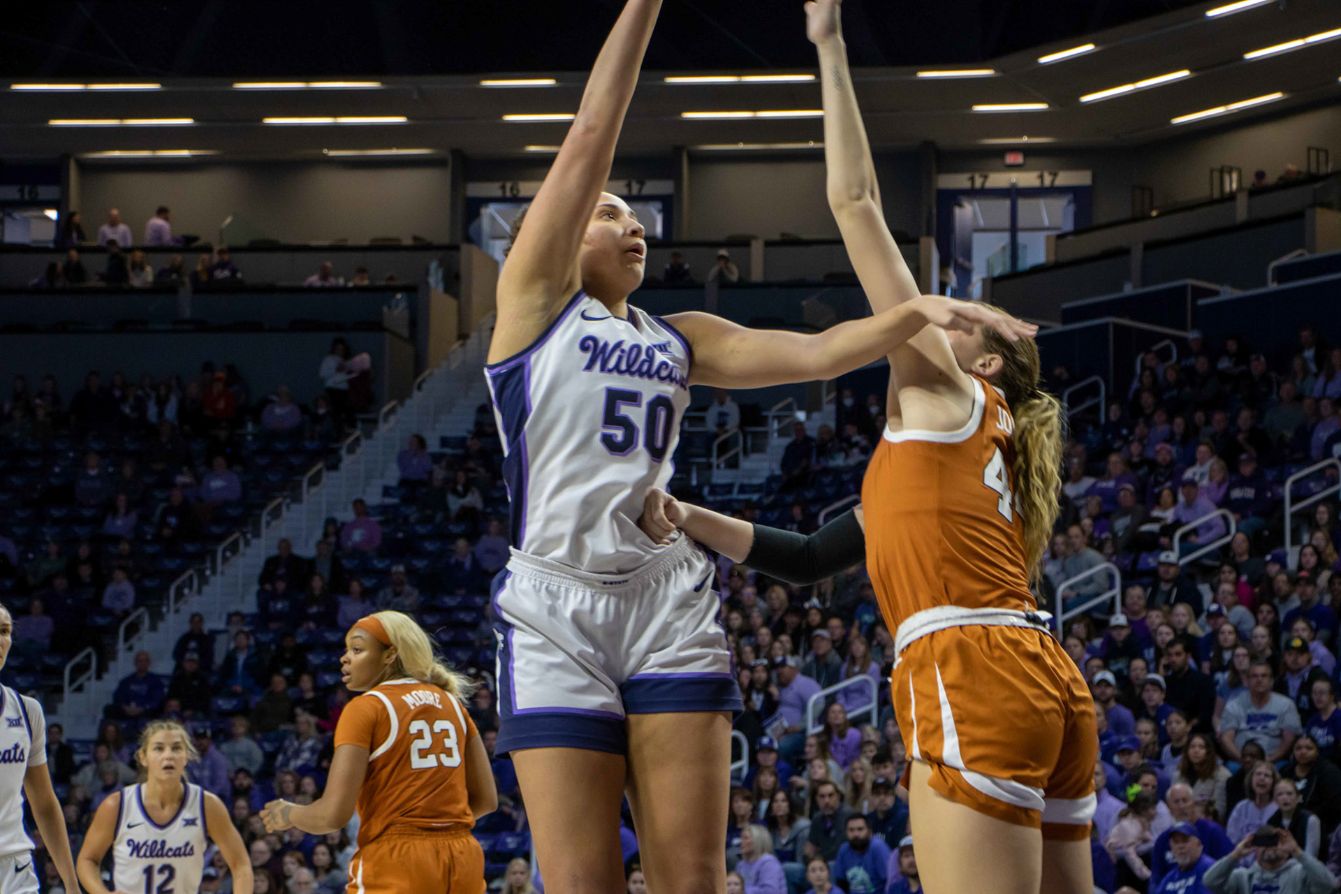 Center Ayoka Lee goes for a jumper against Texas forward Taylor Jones. Lee ended the afternoon as the Wildcats' leading scorer with 21.