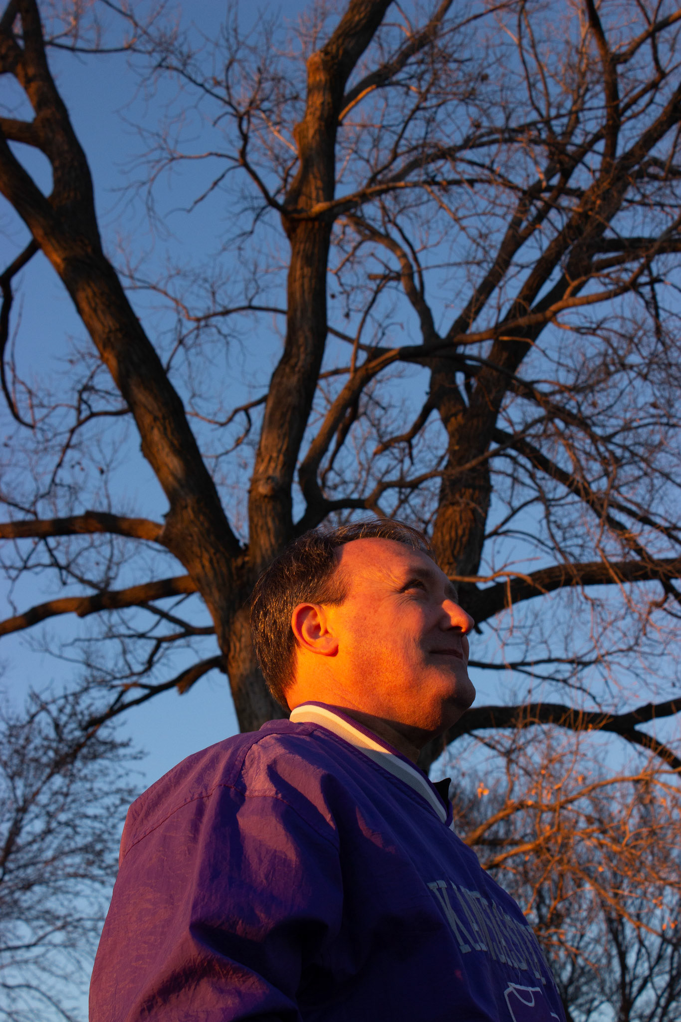 Standing gallantly, Troy stands in front of a cotton wood tree he used to climb as a kid.