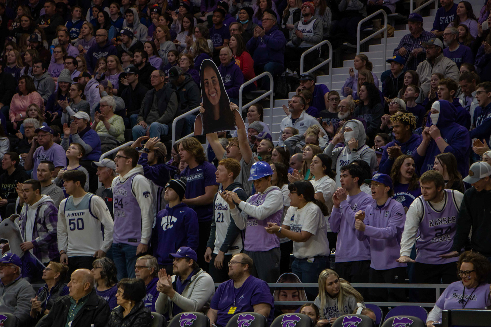 Fans hold up a cutout of center Ayoka Lee as the No. 12 Wildcats took on the No. 10 Texas Longhorns. The game had 7,000 in attendance and also marked the two millionth person to watch the K-State women's basketball team at Bramlage Coliseum.