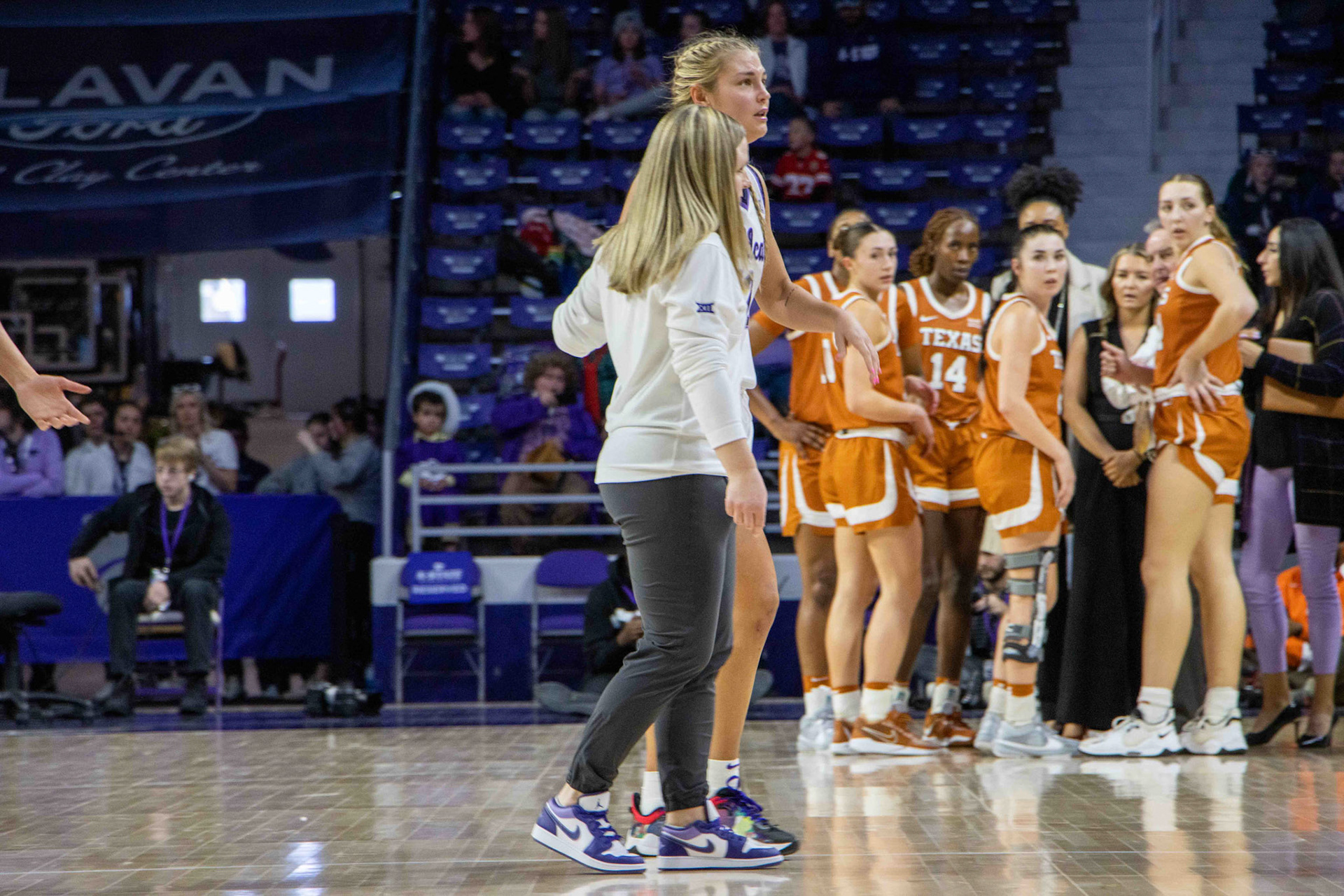 A teary-eyed Gabby Gregory walks back to the bench in the fourth quarter after reaggravating her ankle injury from earlier in the game. Assistant athletic trainer Erin Greenwald helped the guard back, providing support to lean on.