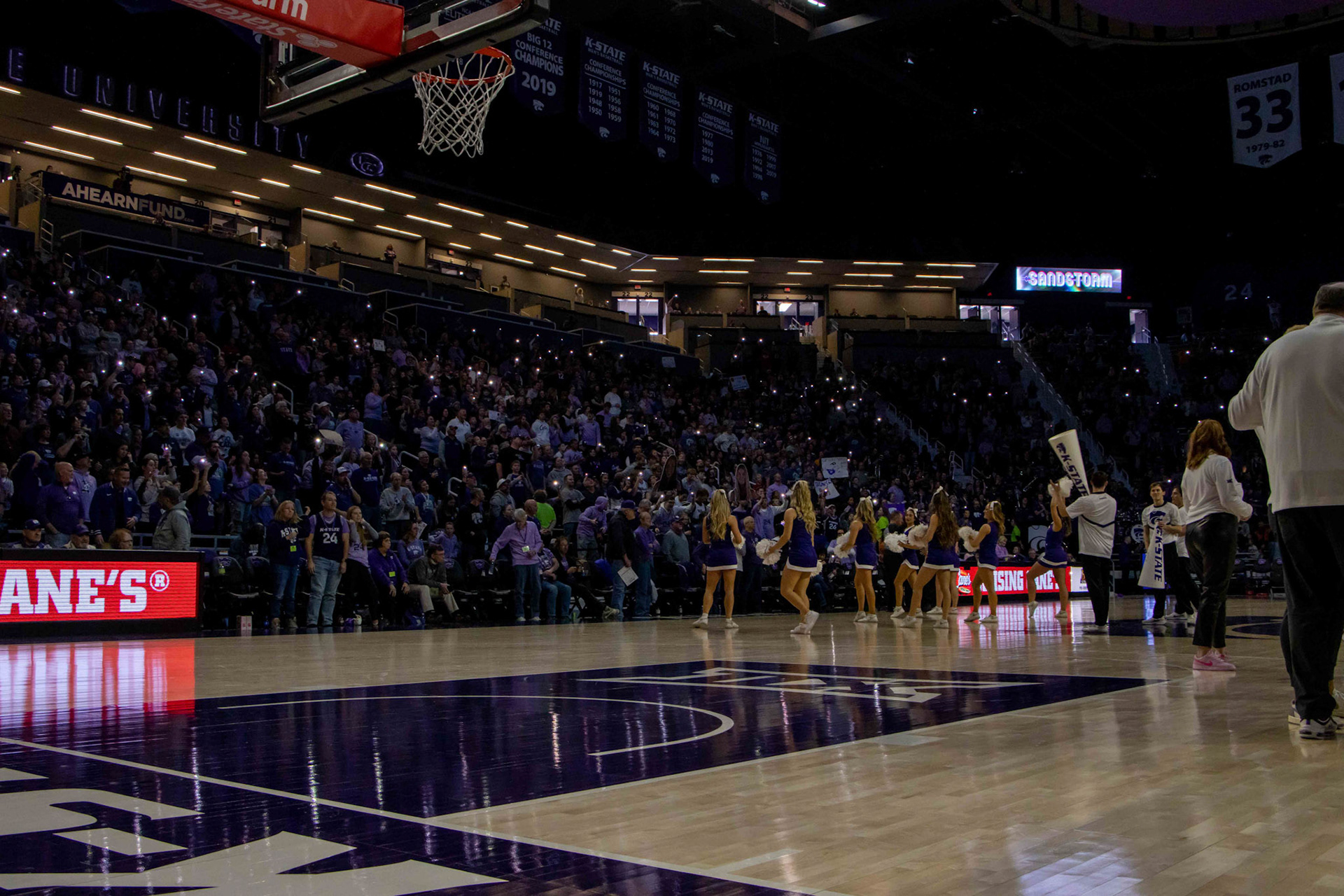 Phone flashlights illuminate Bramlage Coliseum as Darude's Sandstorm starts to fill the arena. Sandstorm is one of many K-State traditions — especially to Bramlage and the basketball teams.