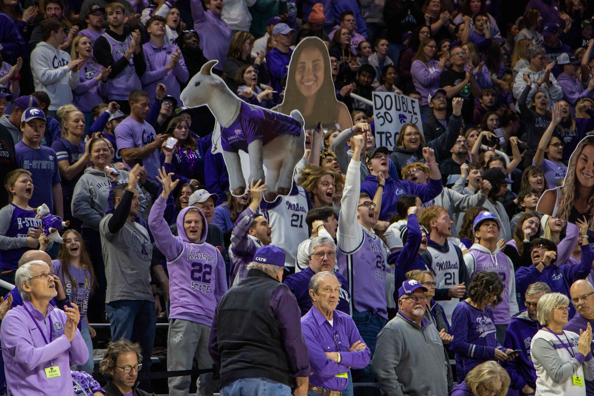 The student section is brought to its feet as Texas takes a timeout early in the fourth quarter due to an 11-0 run from the Wildcats. Students held cutouts and signs as Darude's Sandstorm started to fill Bramlage Coliseum.
