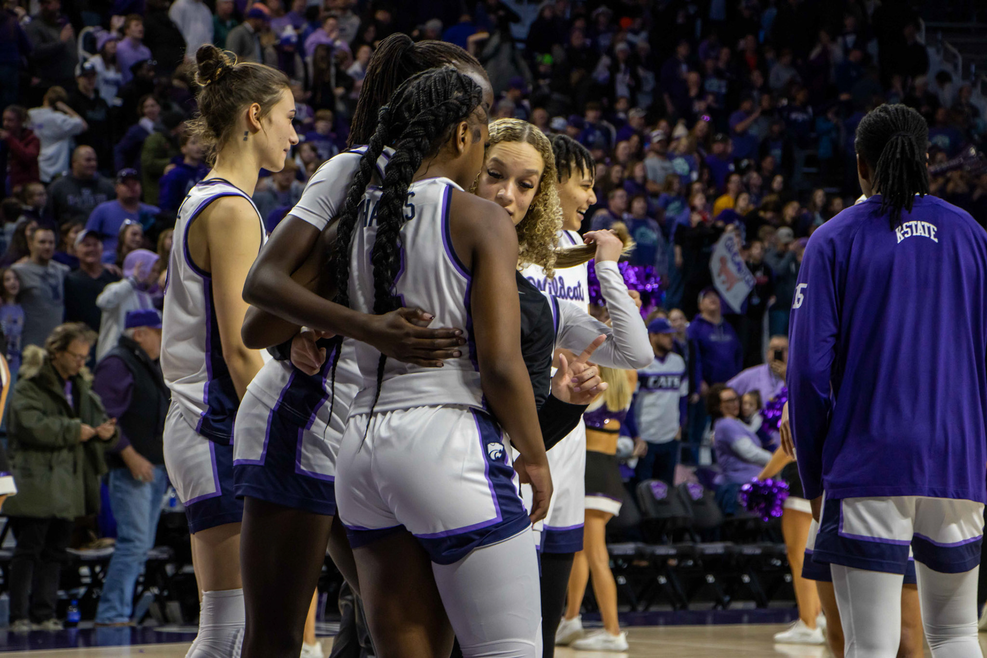 Guard Mikayla Parks embraces with guard Jamia Harris and forward Eliza Maupin after defeating Texas 61-58 Jan. 13, 2024. The Wildcats move to 17-1 on the season and remain undefeated in conference play with the win.