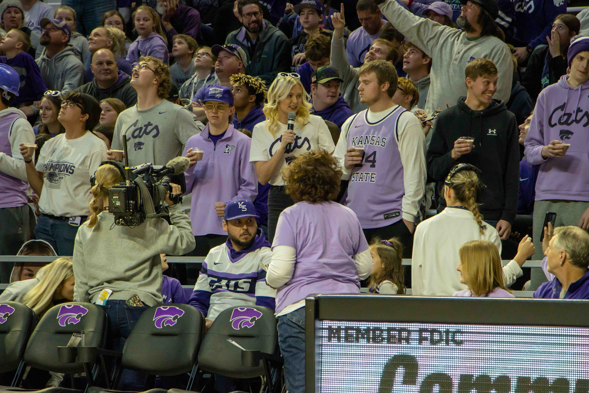 During a break in the second quarter, K-State students have a chocolate milk chugging relay. Marika Davis, senior in mass communications and in-stadium gameday host, explains the Wonka-themed game.