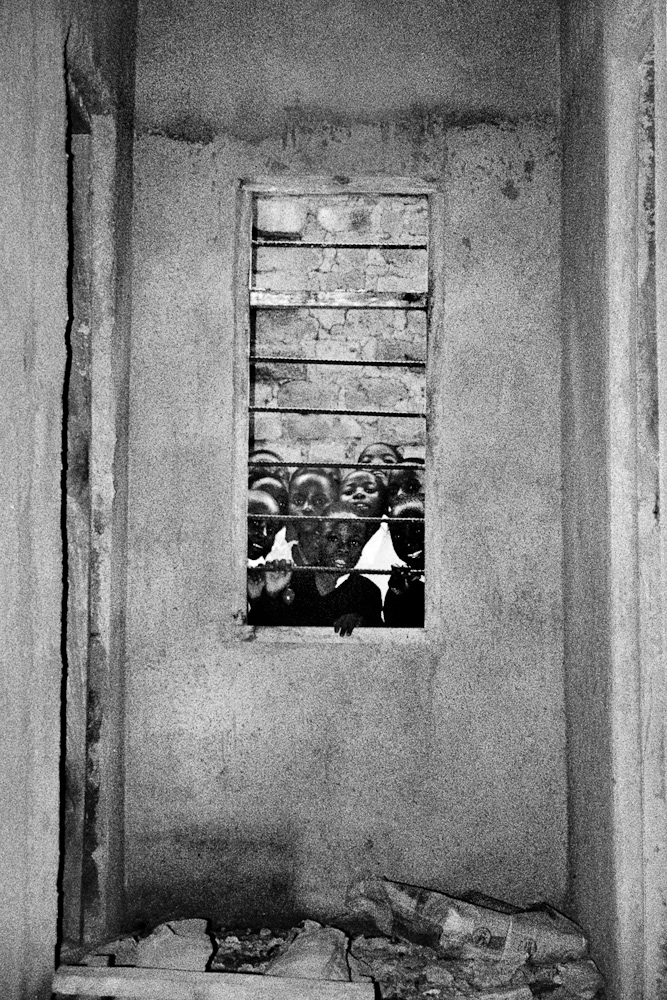 A group of school children gather around the window of our classroom on our first day in the village. All were keen to get a glimpse of the newcomers from the West