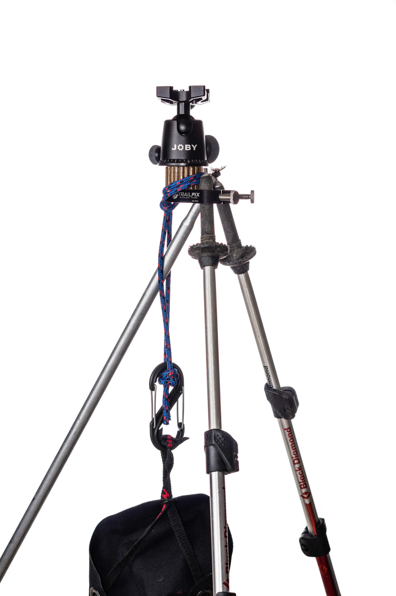 An extra pole is helpful. In this case, two sections from a Timberline tent. Hanging a weight from the center adds stability.