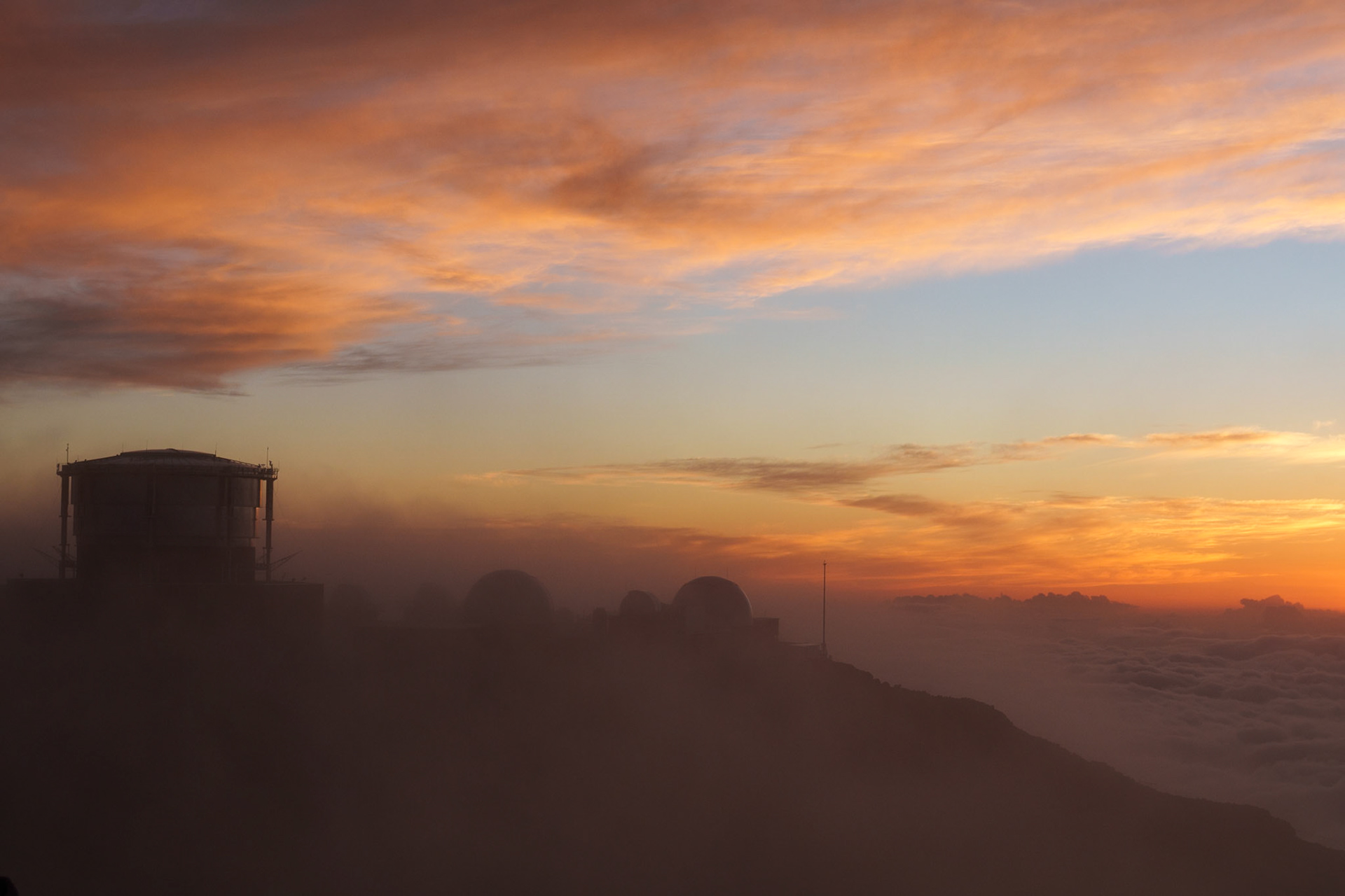 Clouds parting just as the sun sets at Haleakala National Park