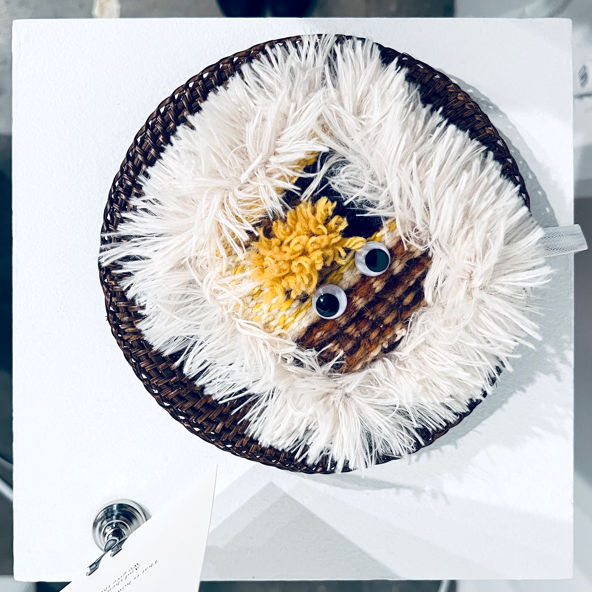 Handwoven textile cake square created by Rao in response to an AI generated food poem