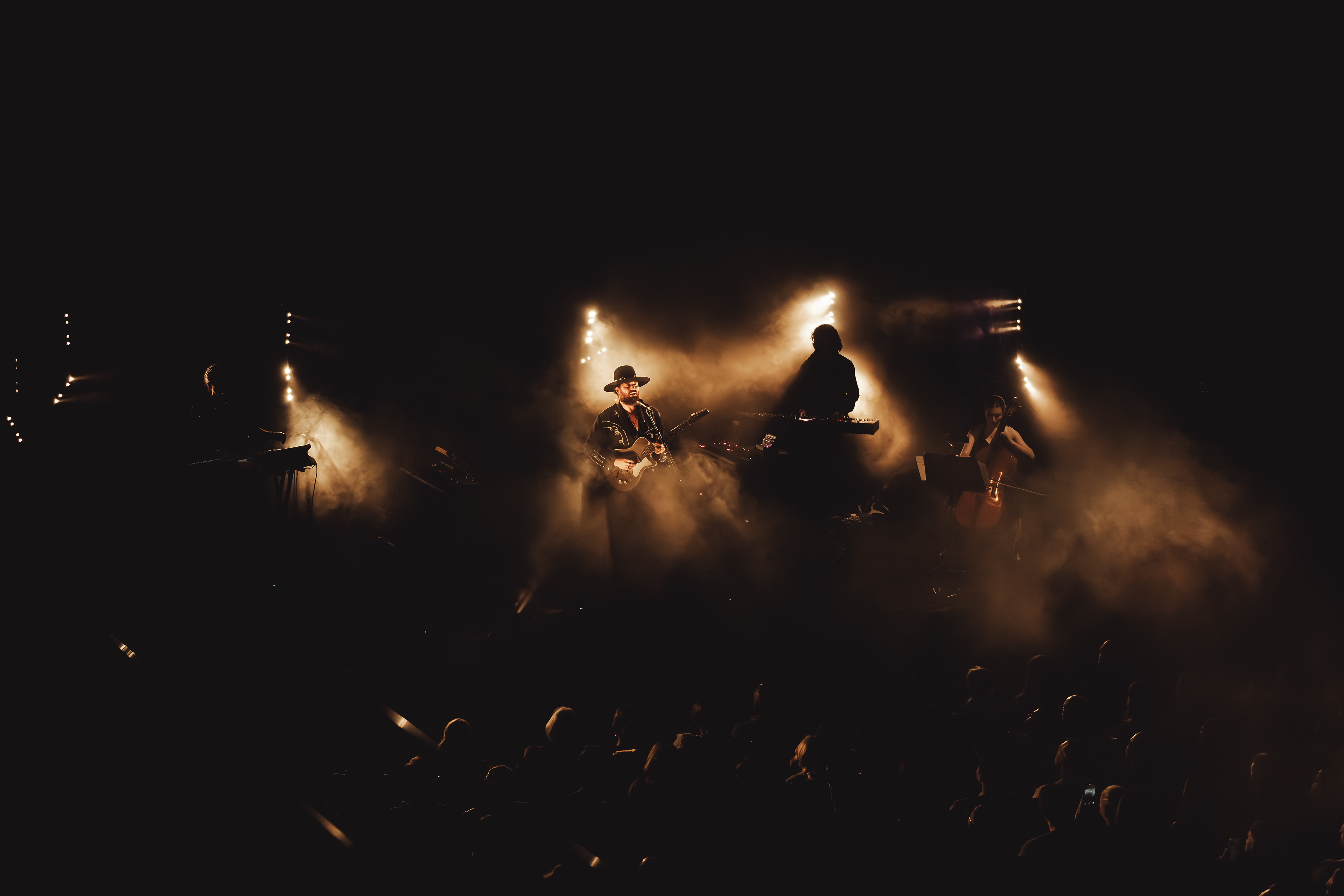 Artist mid-performance during Sydney gig, captured with cinematic tones by Vitor Duarte
