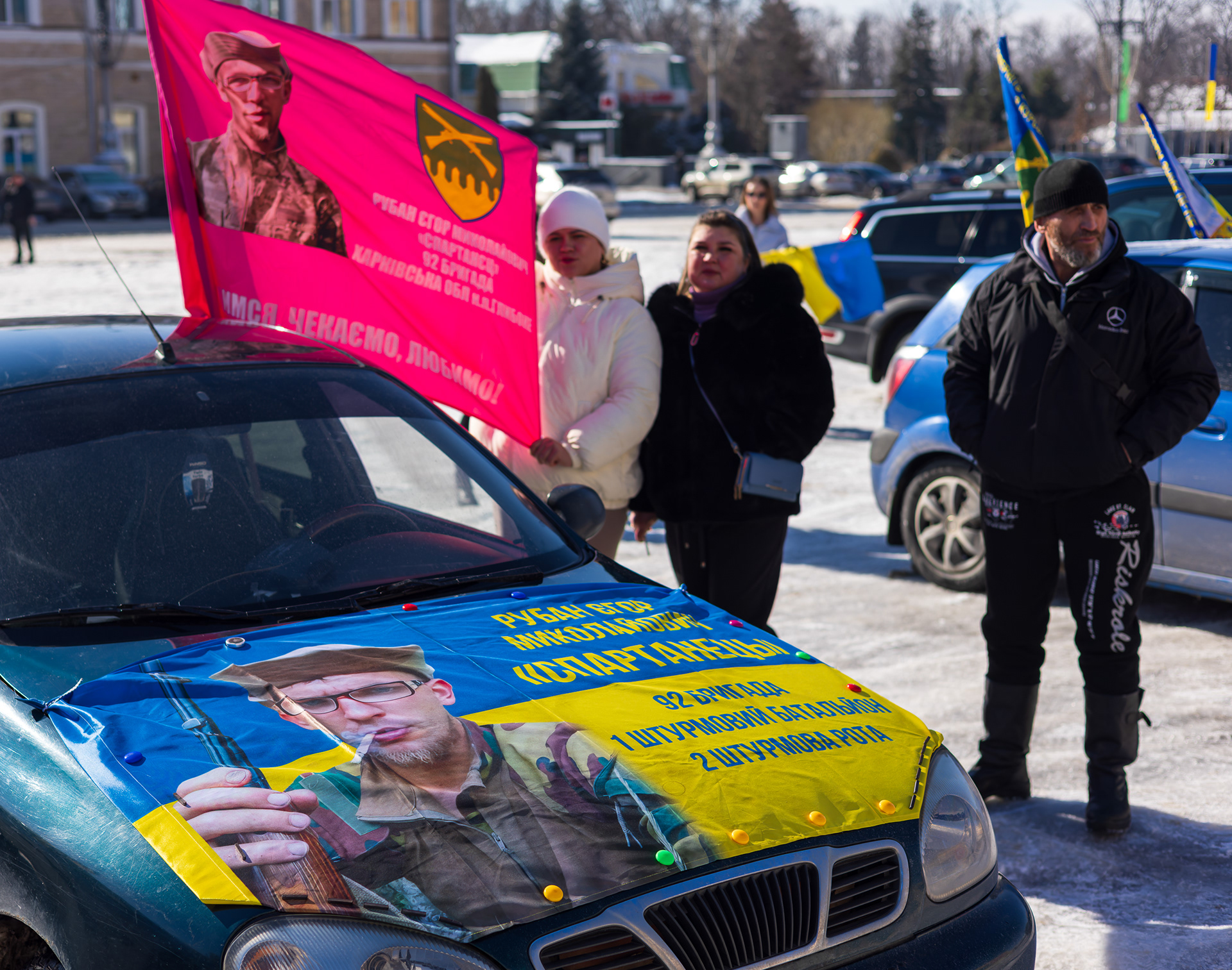 Families setup vehicles that loop through the street between the two rows of people on either side
