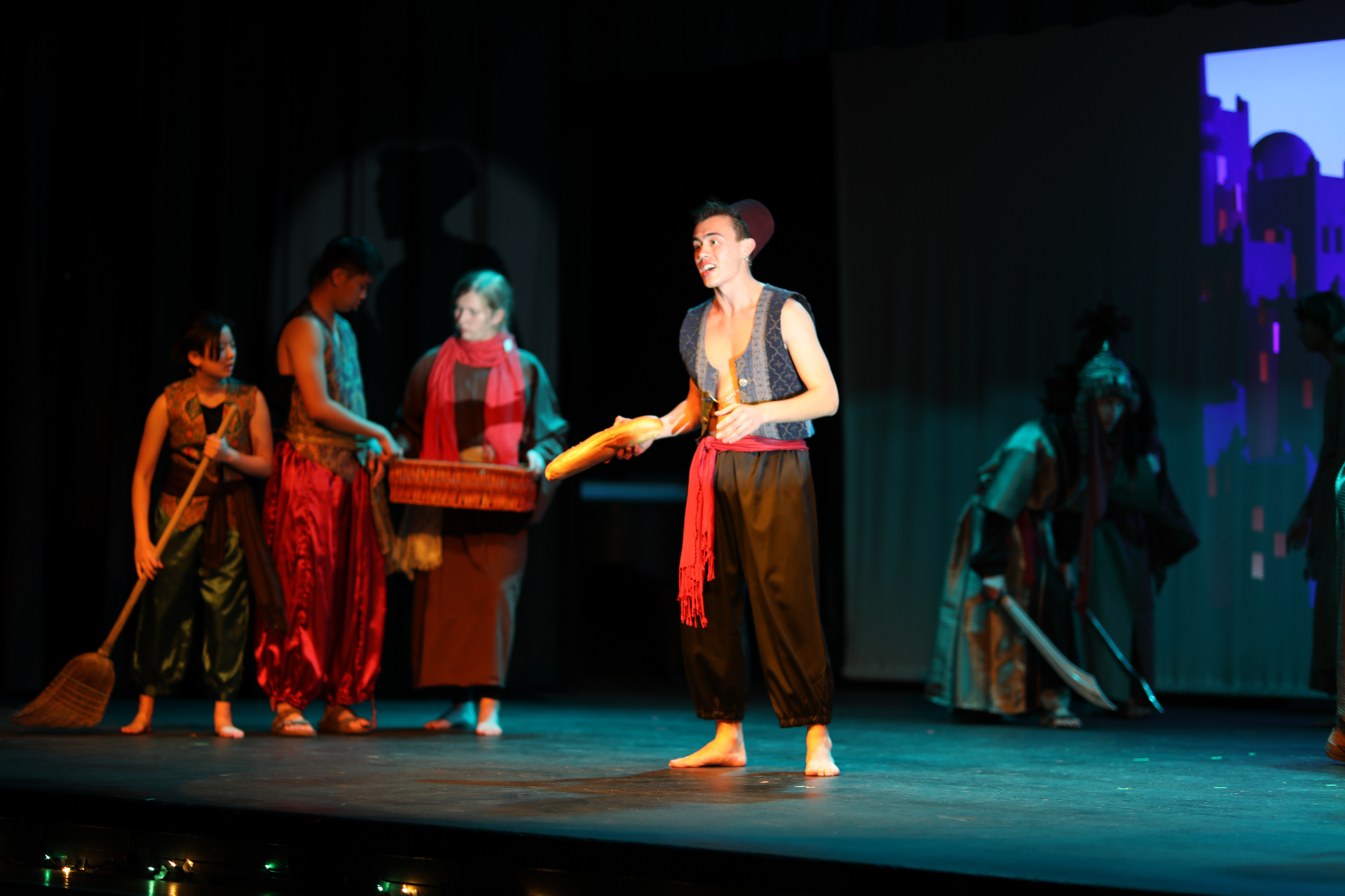 Aladdin makes his way through a bazaar.