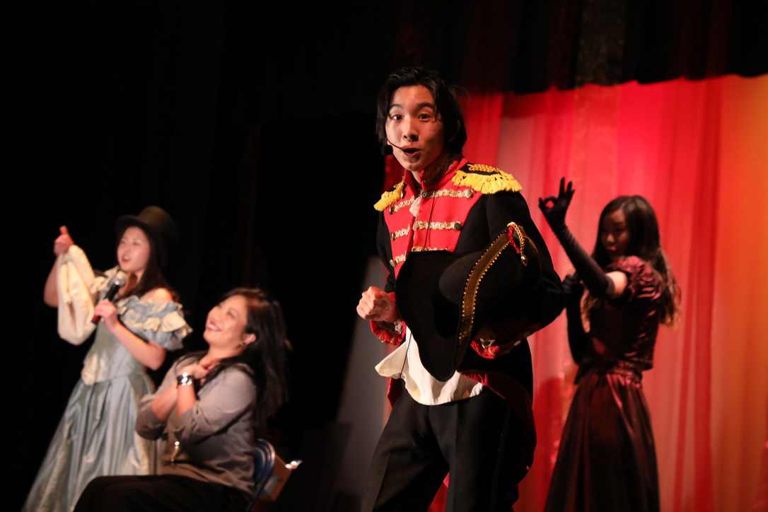 A Master of the House faces the audience.