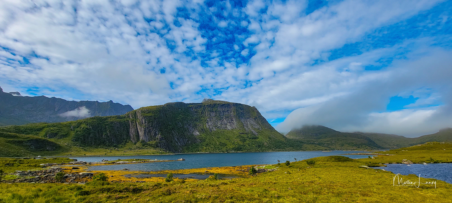 Light clouds over a mountainous seaside