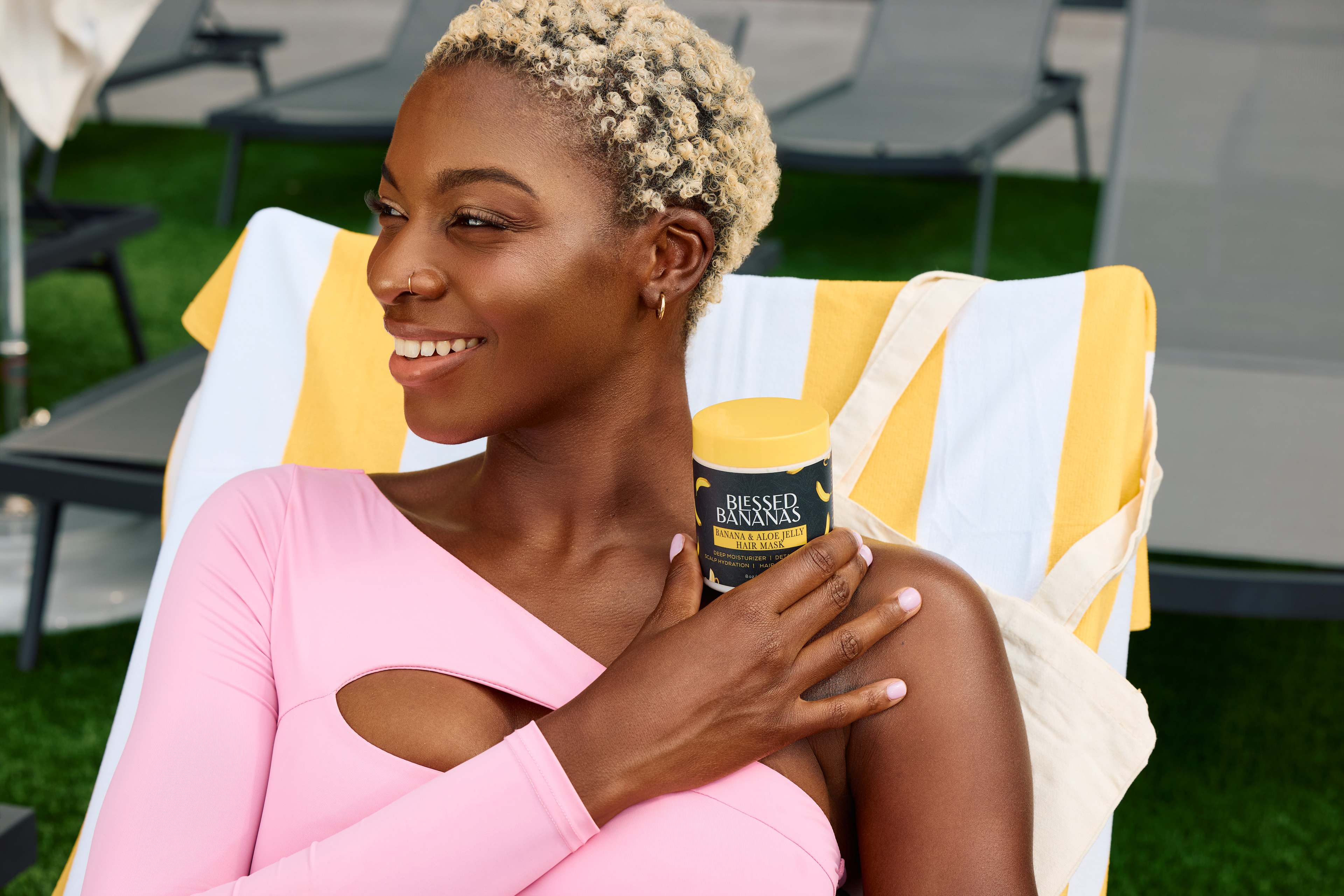 Lifestyle beauty campaign photography featuring natural hair and summer poolside setting for Blessed Bananas.