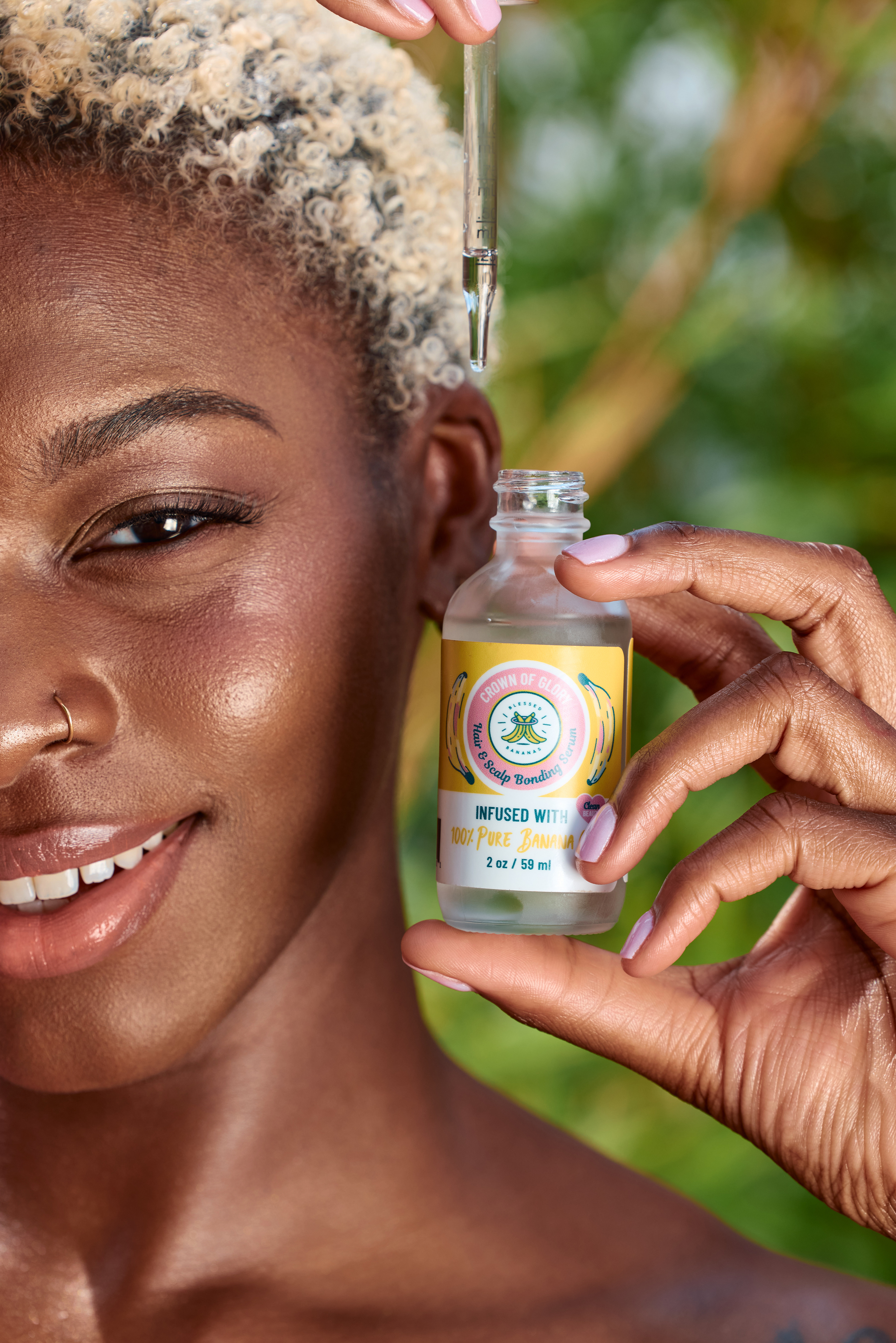 Close-up beauty photography featuring Blessed Bananas hair oil product.