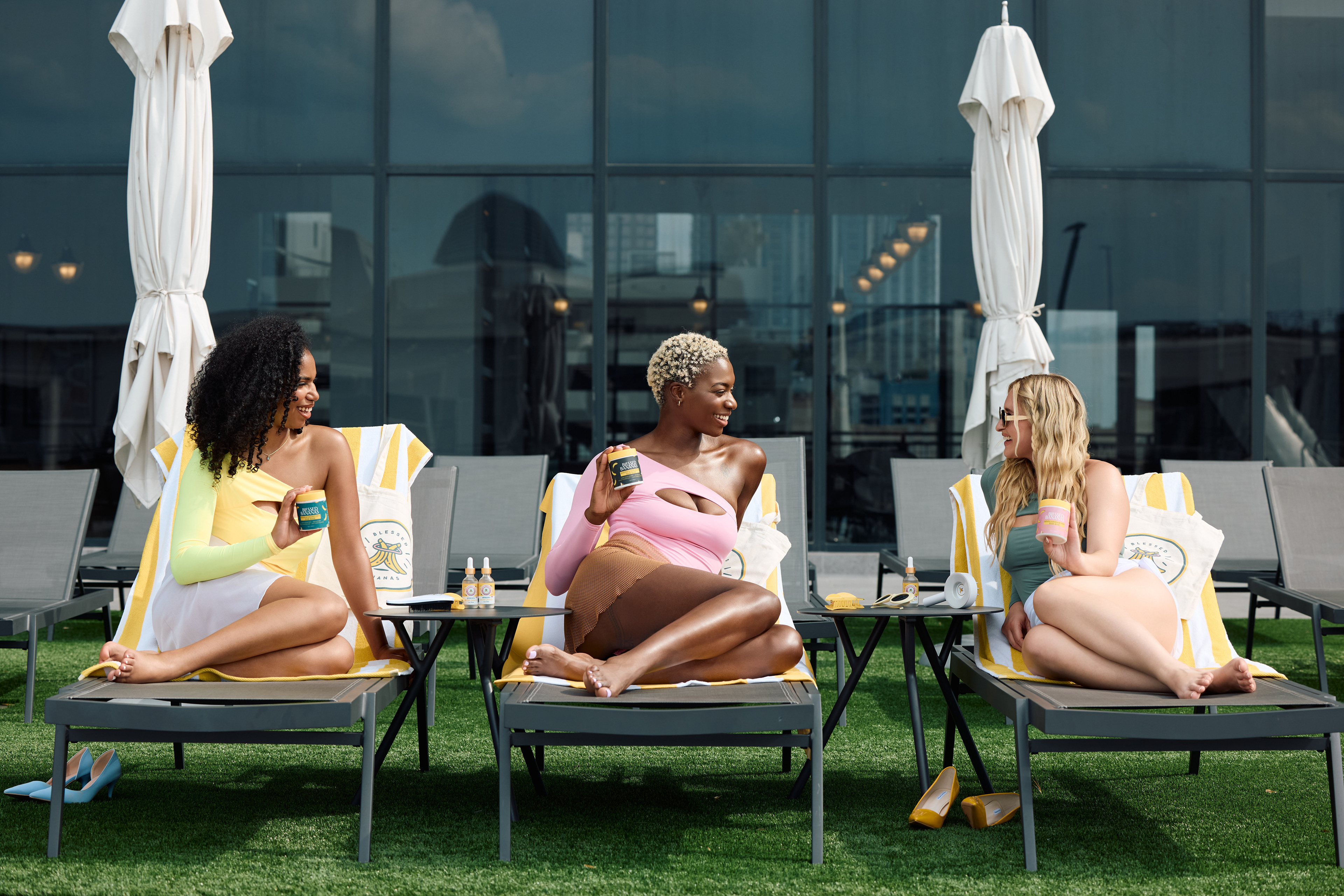 Poolside lifestyle campaign photography featuring diverse beauty models for Blessed Bananas